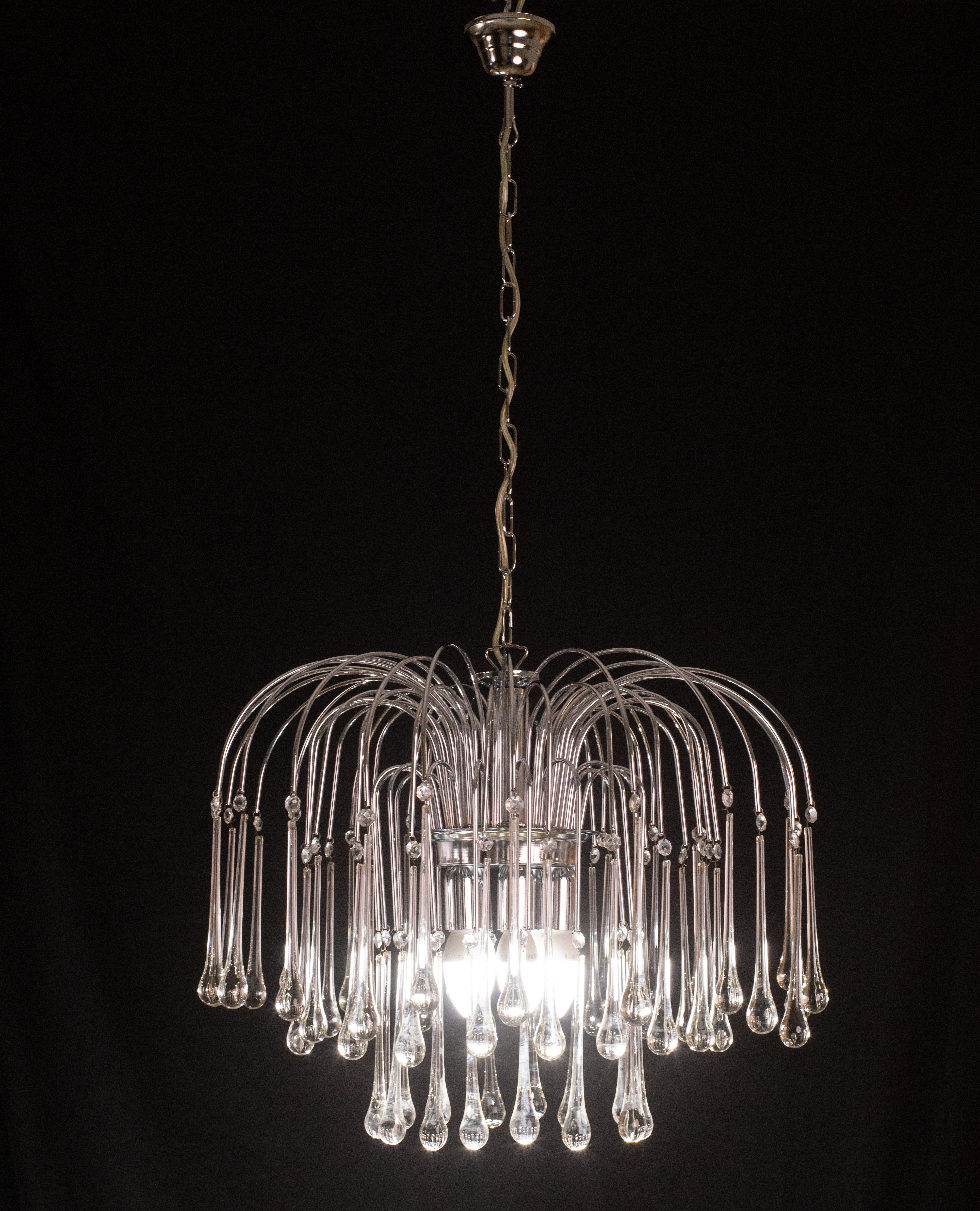 Stunning Murano chandelier in the style of Venini La Cascata.
The chandelier consists of three laps composed of beautiful transparent white drops cascading down each with a crystal attached.
The frame is nickel-plated silver and compleatly new.
The