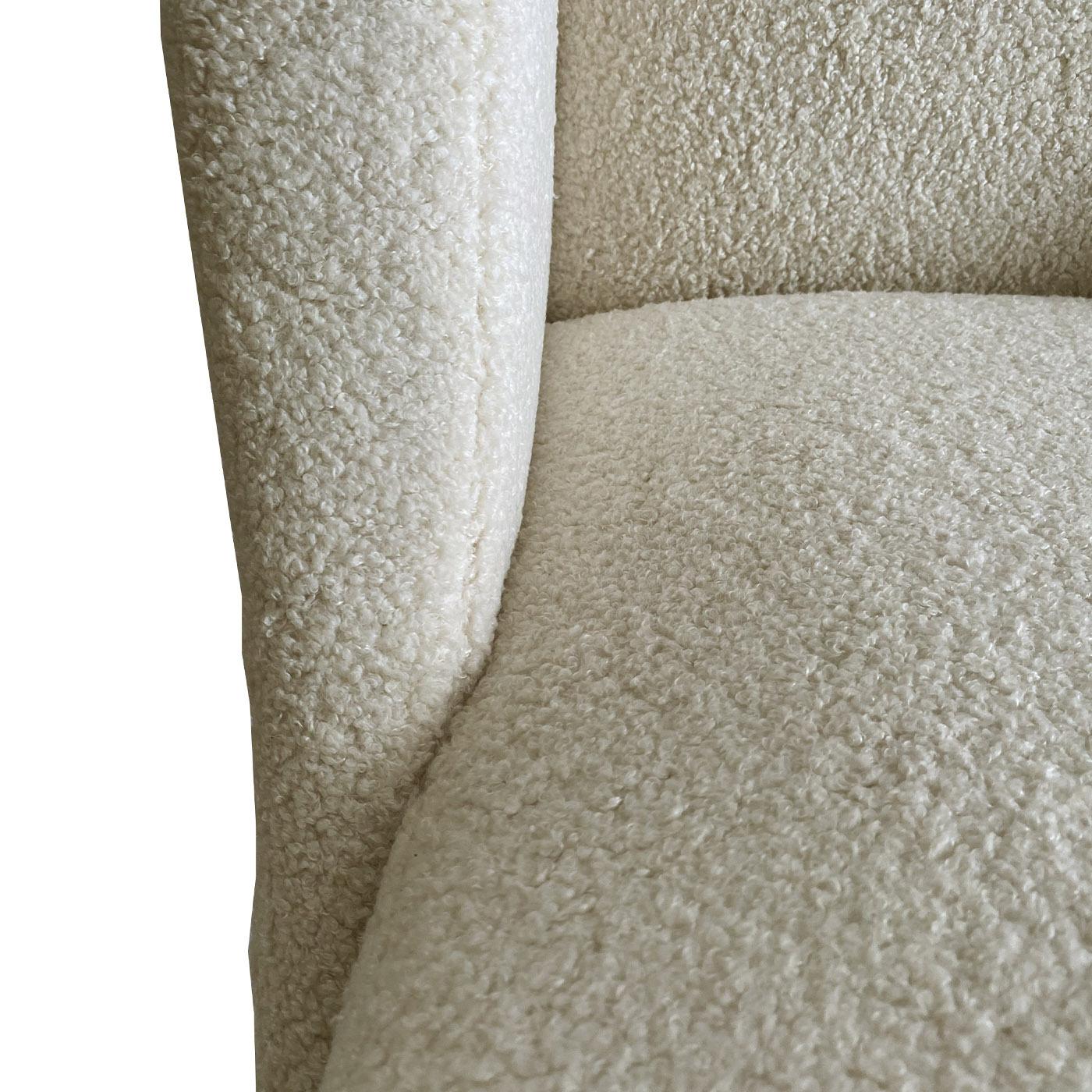 This refined '50s-style armchair is defined by generous curves forming a cozy nest to relax. Sustainability and reuse are the key principles behind its design, from energy consumption to materials, including the soft and luminous fabric upholstery