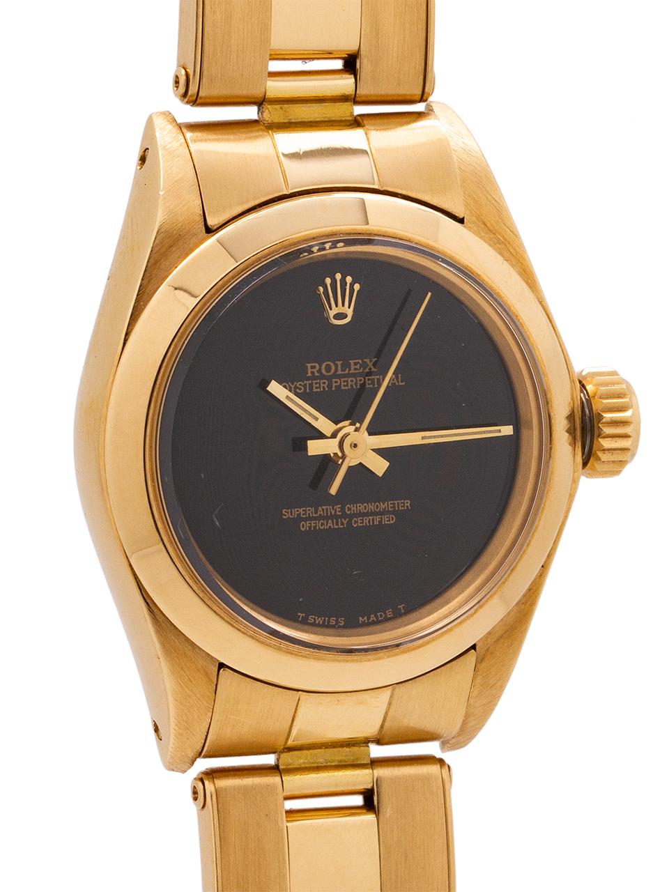 
Lady Rolex Oyster Perpetual 18K YG ref# 6718 serial #4.1 million circa 1976. Featuring 25 mm diameter Oyster case with smooth dome bezel, acrylic crystal, and beautiful condition original champagne dial with applied gold indexes and gilt baton