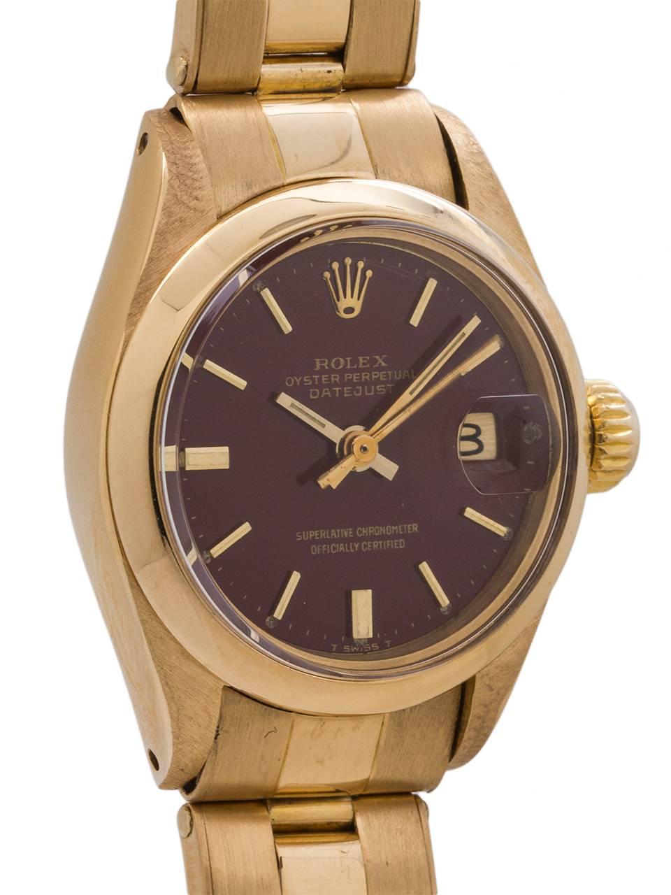 
Ultra rare lady’s Rolex Oyster Perpetual Date 18K yellow gold ref 6916 4 million serial # circa 1974, with original oxblood Stella dial. Featuring 26mm diameter case with smooth bezel, acrylic crystal, and original oxblood color stella dial with
