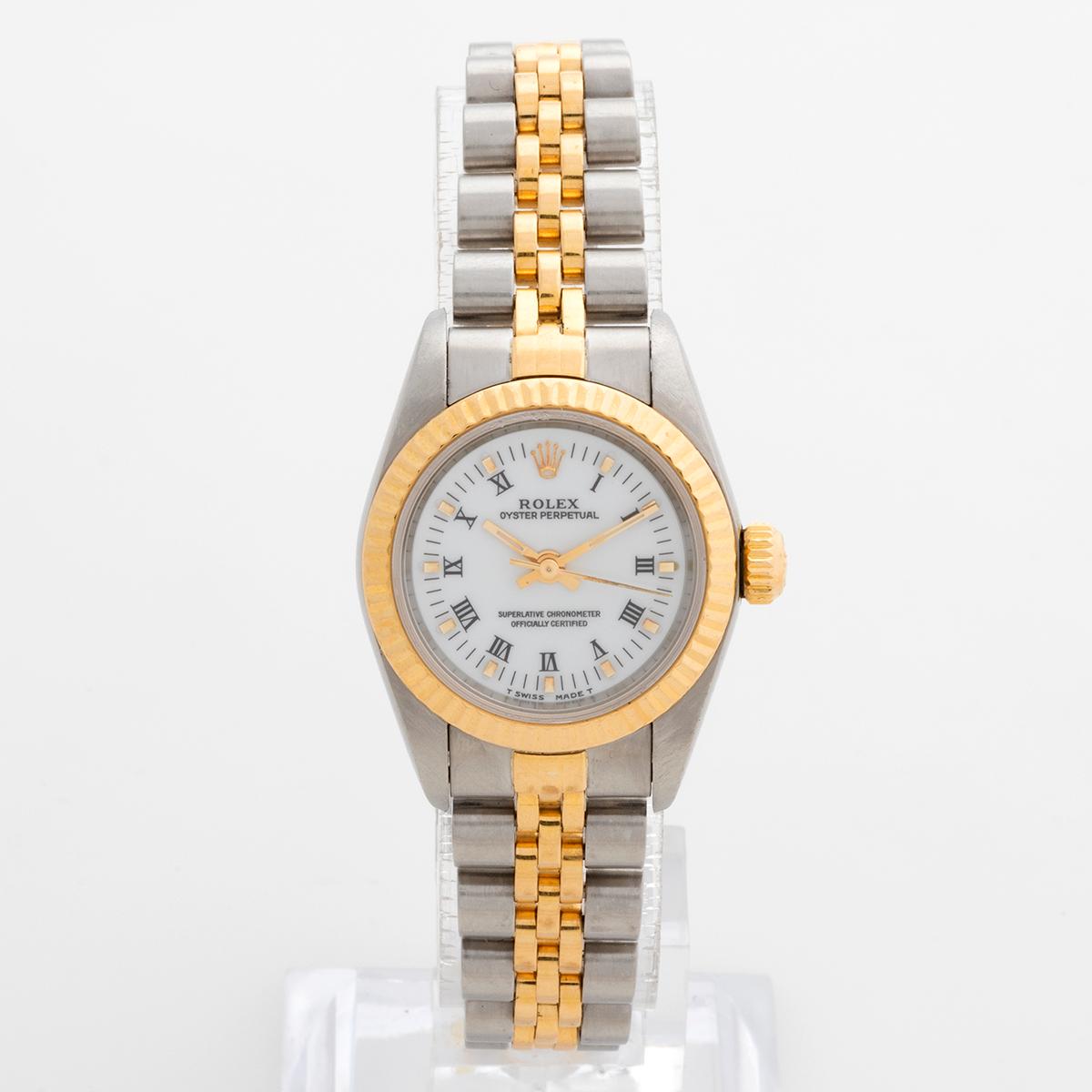 Our classic neo vintage Lady Rolex Oyster Perpetual features a 26mm stainless steel and yellow gold case and stainless steel and yellow gold jubilee bracelet and notably a white roman numeral dial. This reference 67193 is presented in excellent