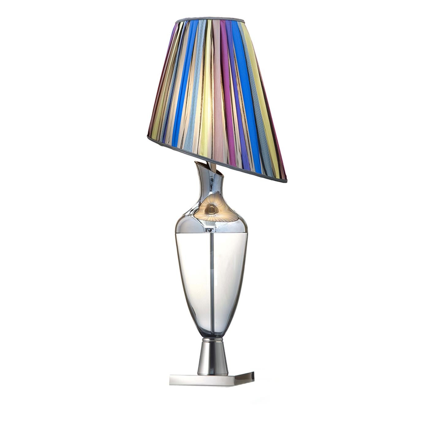This elegant table lamp will add a colorful accent to any interior, thanks to the mirrored effect of its asymmetrical shade that reflect the light of its E27 x 60 W bulb in a dazzling manner. The inner structure of the piece and its square base are
