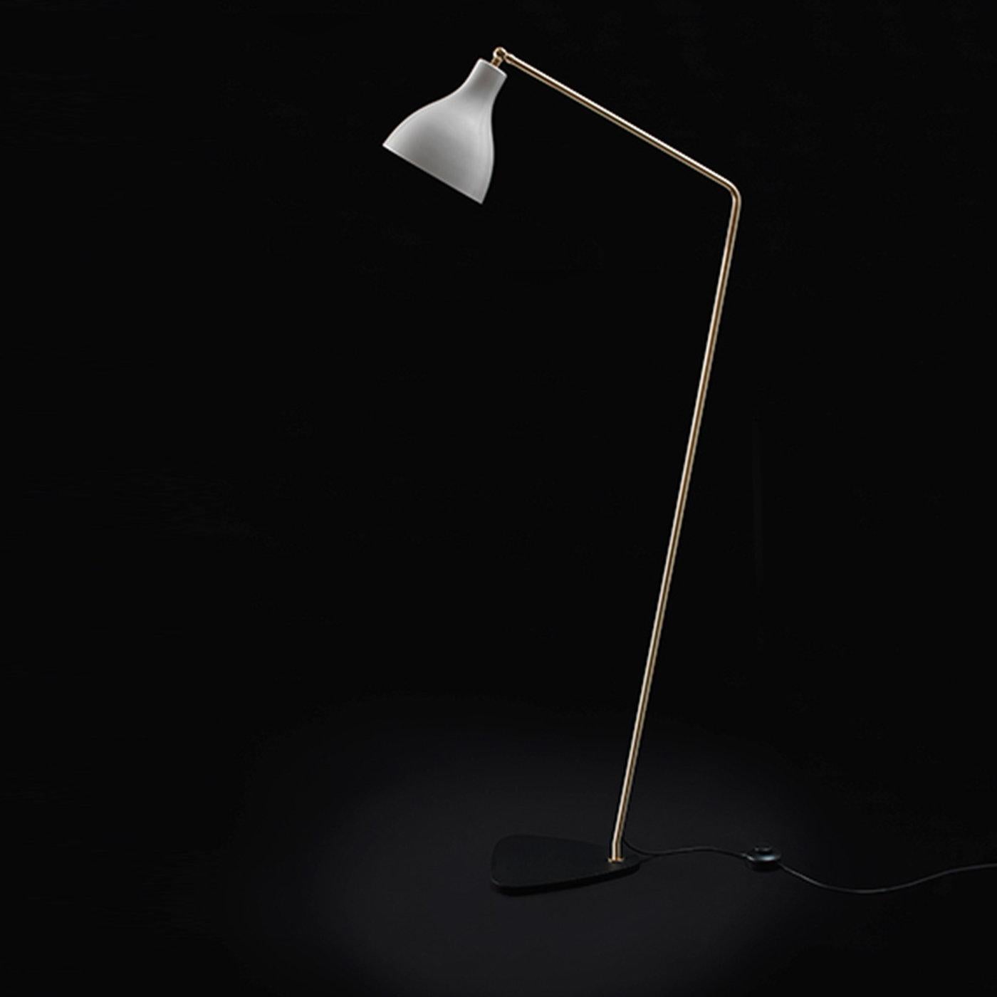 Elegant and slender slanted floor lamp with brass body painted aluminum shade, and iron base. Can also be ordered in the following combinations: brass/shiny white, brass/texturized black, chrome/texturized black.
