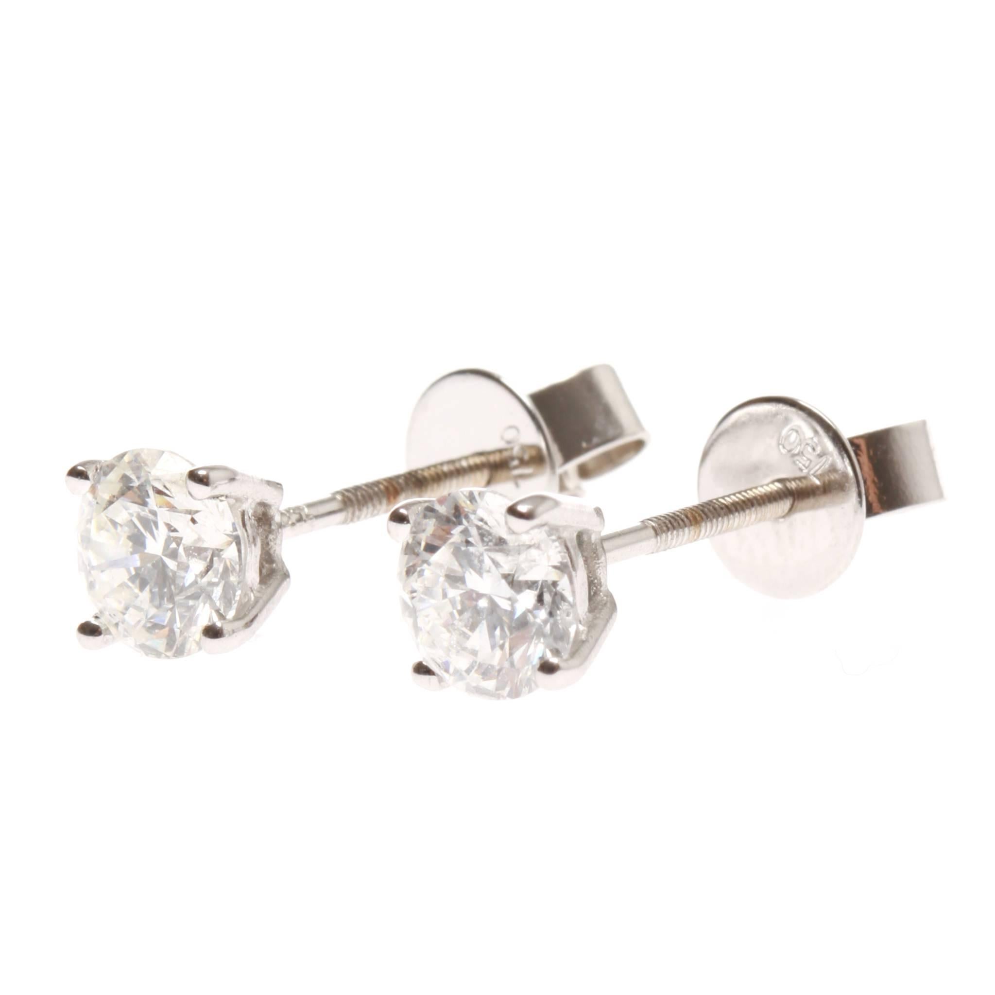 	
One pair of lady's, hand assembled, 18ct white gold diamond set earrings.
Of stud style with each earring having a single, 4 claw and single rail style, setting and each housing a single round brilliant cut diamond.
Each earring with a threaded