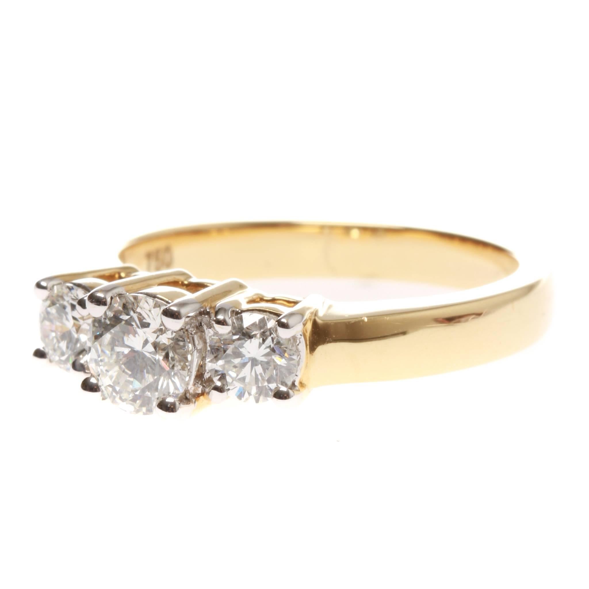 One Lady's, cast, 18ct yellow gold and rhodium plated three stone diamond ring.
Plain and wide, low half round, tapered band of 2.70mm in width (at base) x 1.52mm in depth.
Open setting backs with plain shoulders.
Feature stepped top having three, 4
