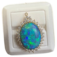 Lady's Black Opal and Pendant in 18k Yellow Gold