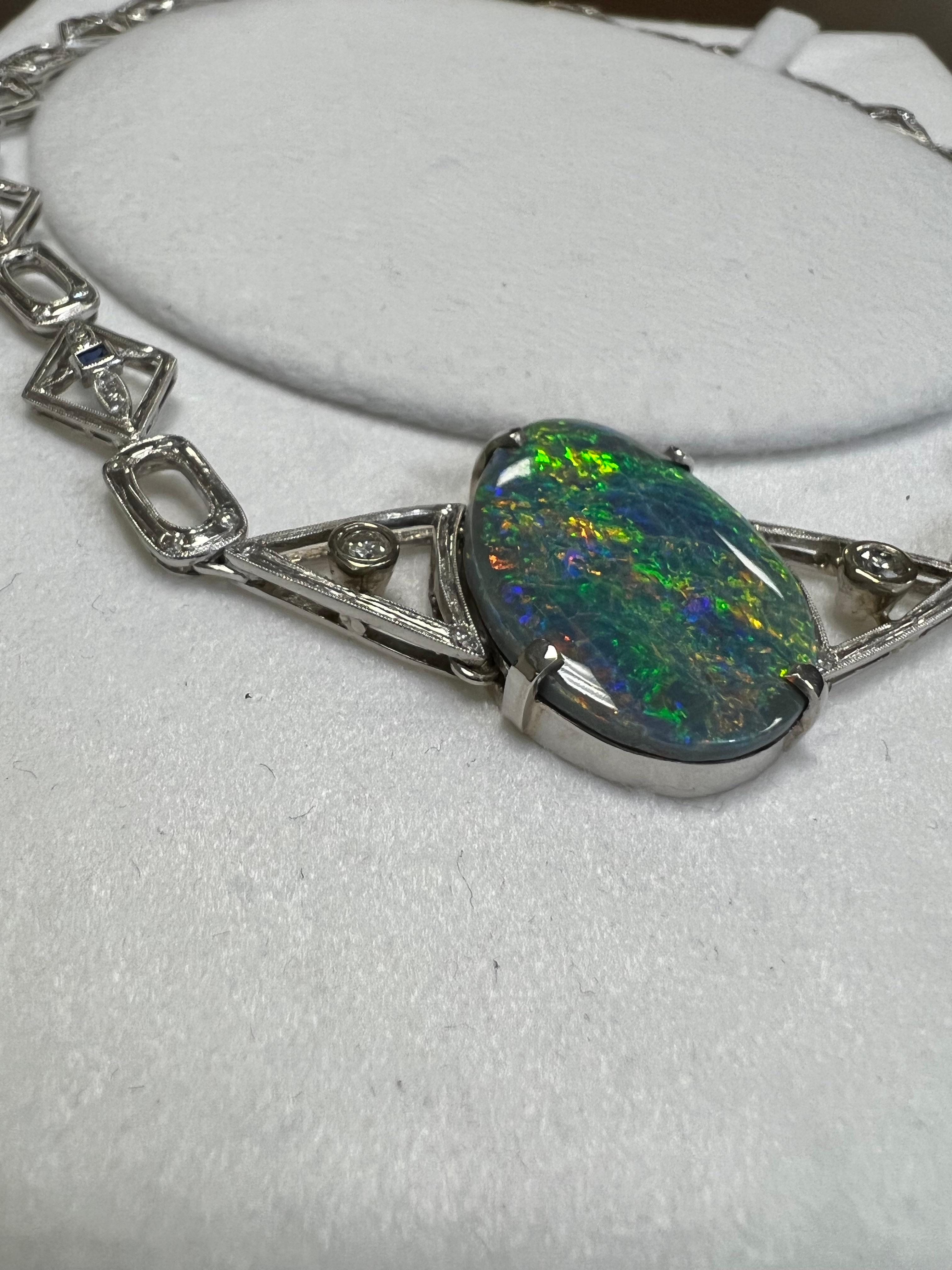 One lady's black opal with a multi-color fire color. Average saturation scale with flash fire pattern. Brightness of fire is bright with cabochon, oval shape. Condition is crazed. Measurements are 33.75 x 22.0 mm. Weight is 32 carats. 106 round