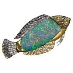 Lady's Boulder Opal, Diamonds and Sapphire "Fish" Broach in 18k Yellow Gold