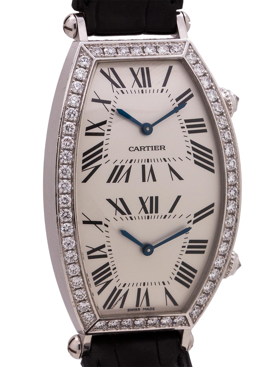   
Pristine condition man’s size Cartier 18K white gold Dual Time Tonneau, circa 2000’s with factory set diamonds. Featuring a classic tonneau case with a beautiful curved back and stylized, slightly protruding lugs. 29 X 43 mm white gold case with