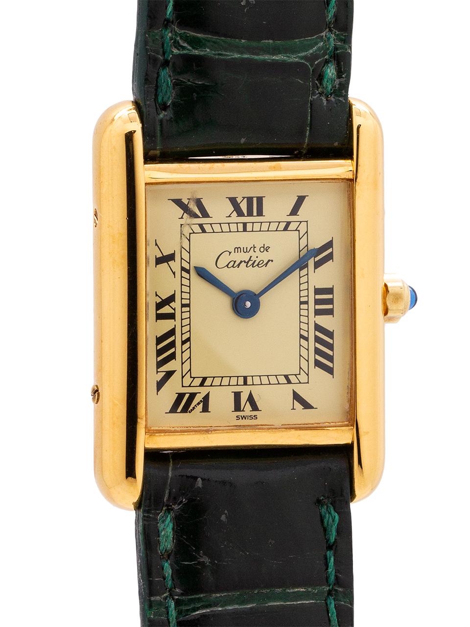 
Cartier Lady’s Tank Louis circa 1990s. Featuring 20 x 28mm vermeil (20 microns gold over silver) case secured by 4 side and 4 case back screws. Featuring classic cream color dial signed Must de Cartier with printed black Roman numerals and blued