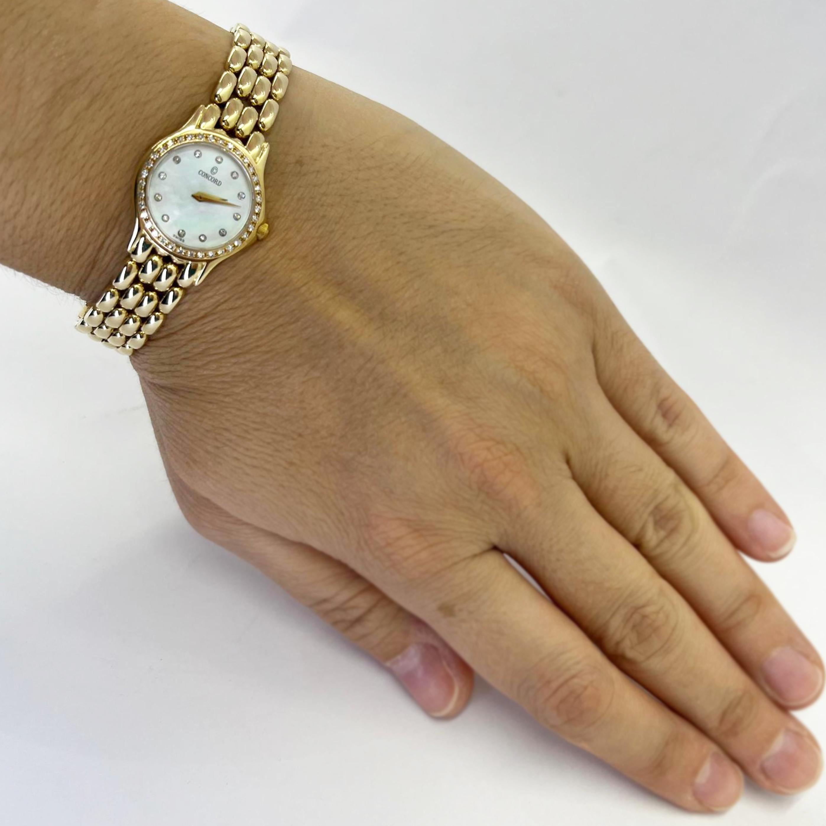 Pre-Owned 14 Karat Yellow Gold Concord Ladies Quartz Watch Featuring A 22mm Case with mother of pearl diamond dial and diamond bezel. Fits up to 6.6 inch wrist. Finished weight is 35.3 grams. 1 year timekeeping warranty and gift box included.