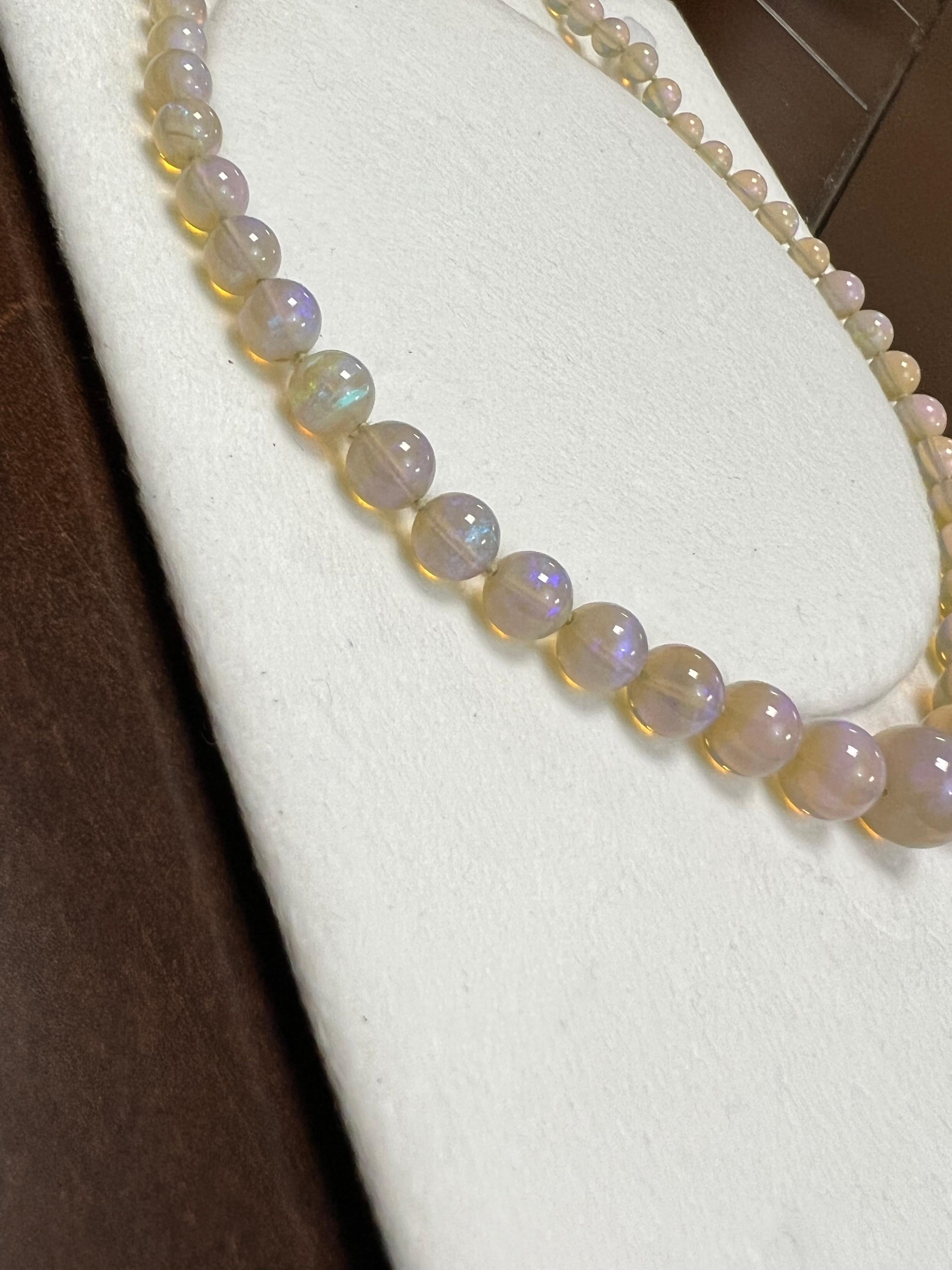 One lady's crystal opal with a multi-color fire color. Average saturation scale with flash fire pattern. Brightness of fire is bright with shape, round beads. Measurements are 14.0-5.0 mm. Gross weight is 190 grams. 