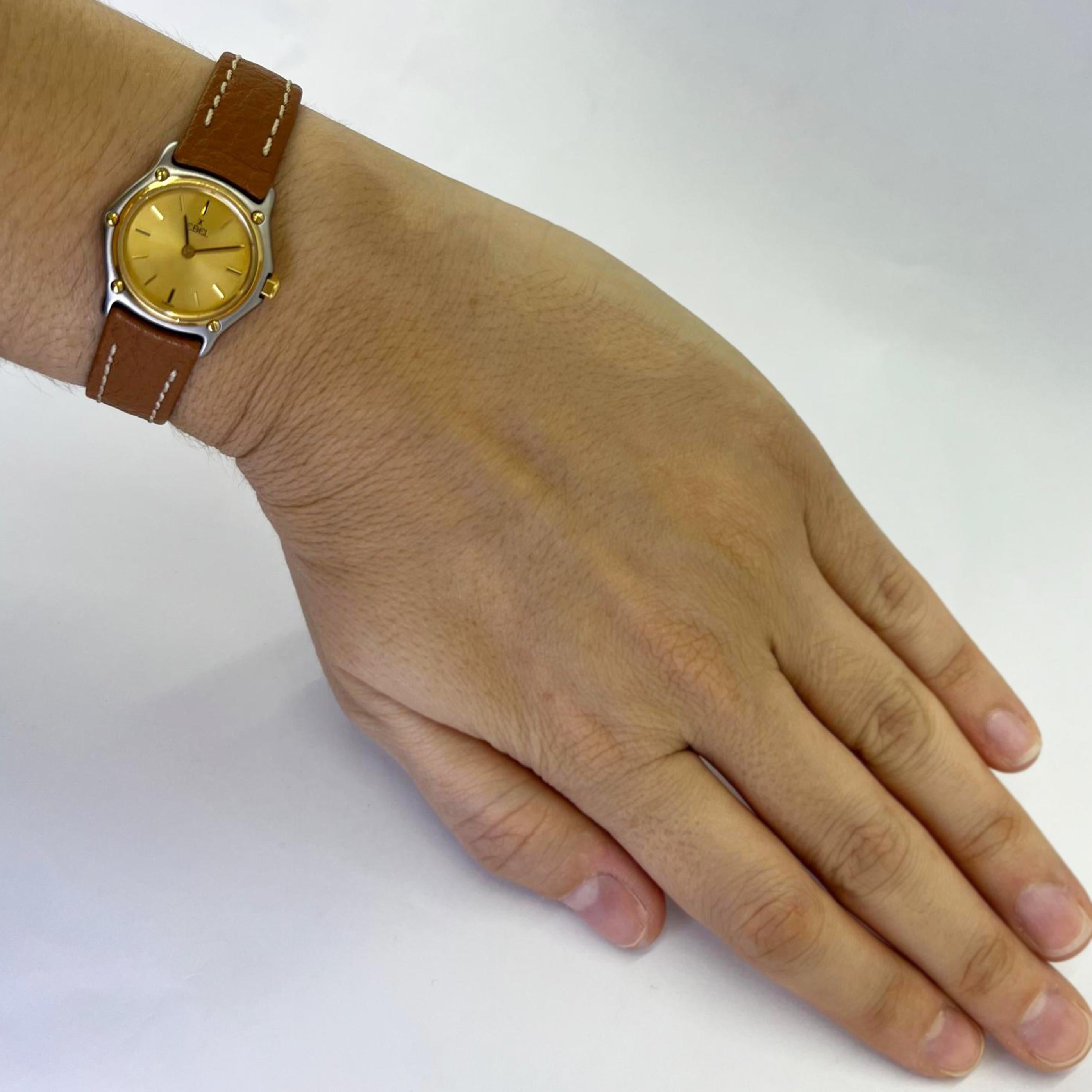 Ebel Sportwave 23mm Quarzuhr aus 18 Karat Gelbgold und Stahl mit champagnerfarbenem Zifferblatt. Modell 166901 mit braunem Kalbslederarmband mit Ebel-Dornschließe und zusätzlichem zweifarbigem Metallarmband. Bedient im Oktober 2024. Inklusive 1 Jahr