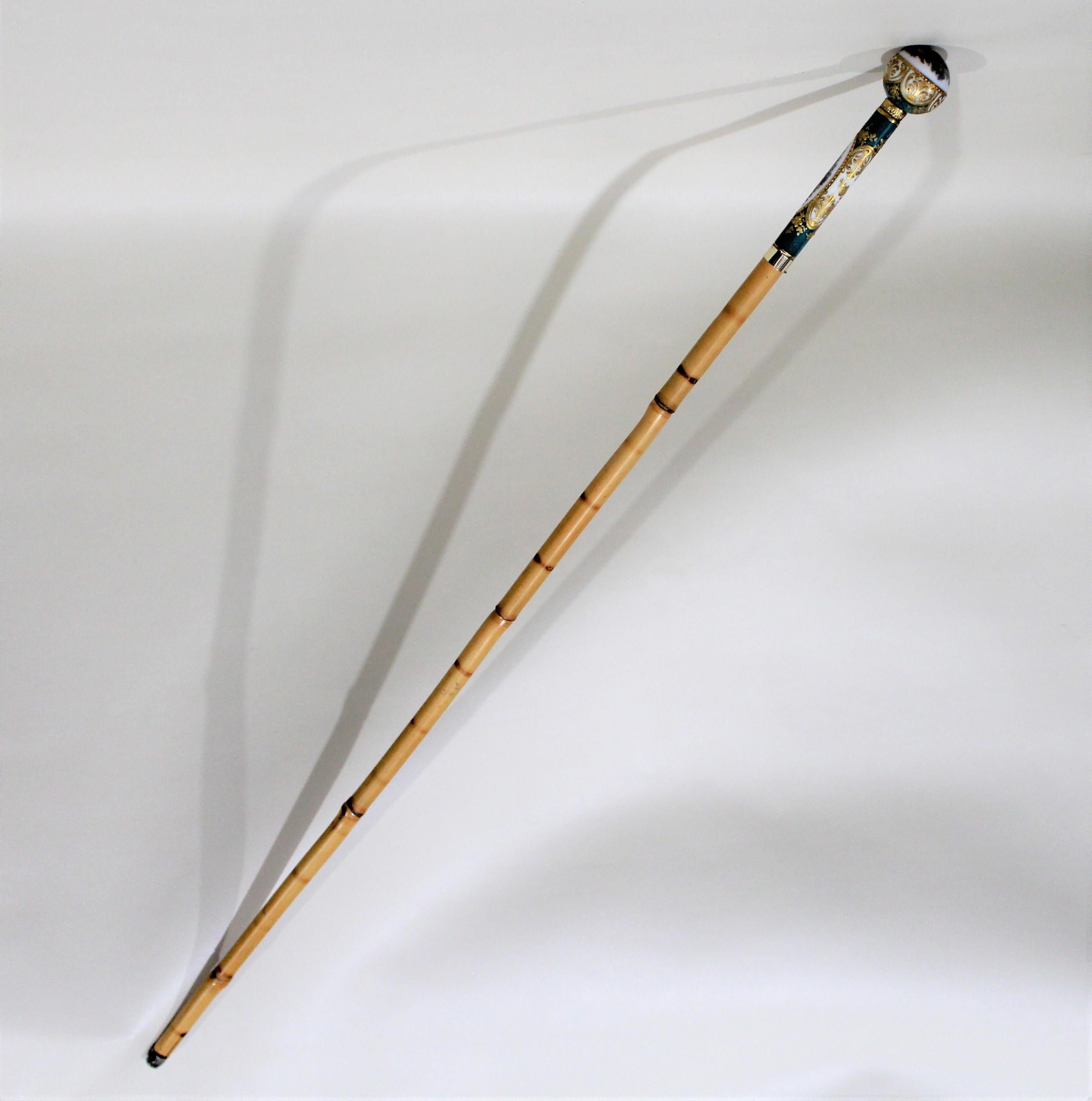Lady's Sevres style French porcelain walking stick. Features a porcelain sphere as a grip which is connected to the shaft with a gilt collar. The wall and sphere both feature figurative scenes and they're decorated with gold gilt floral and foliate