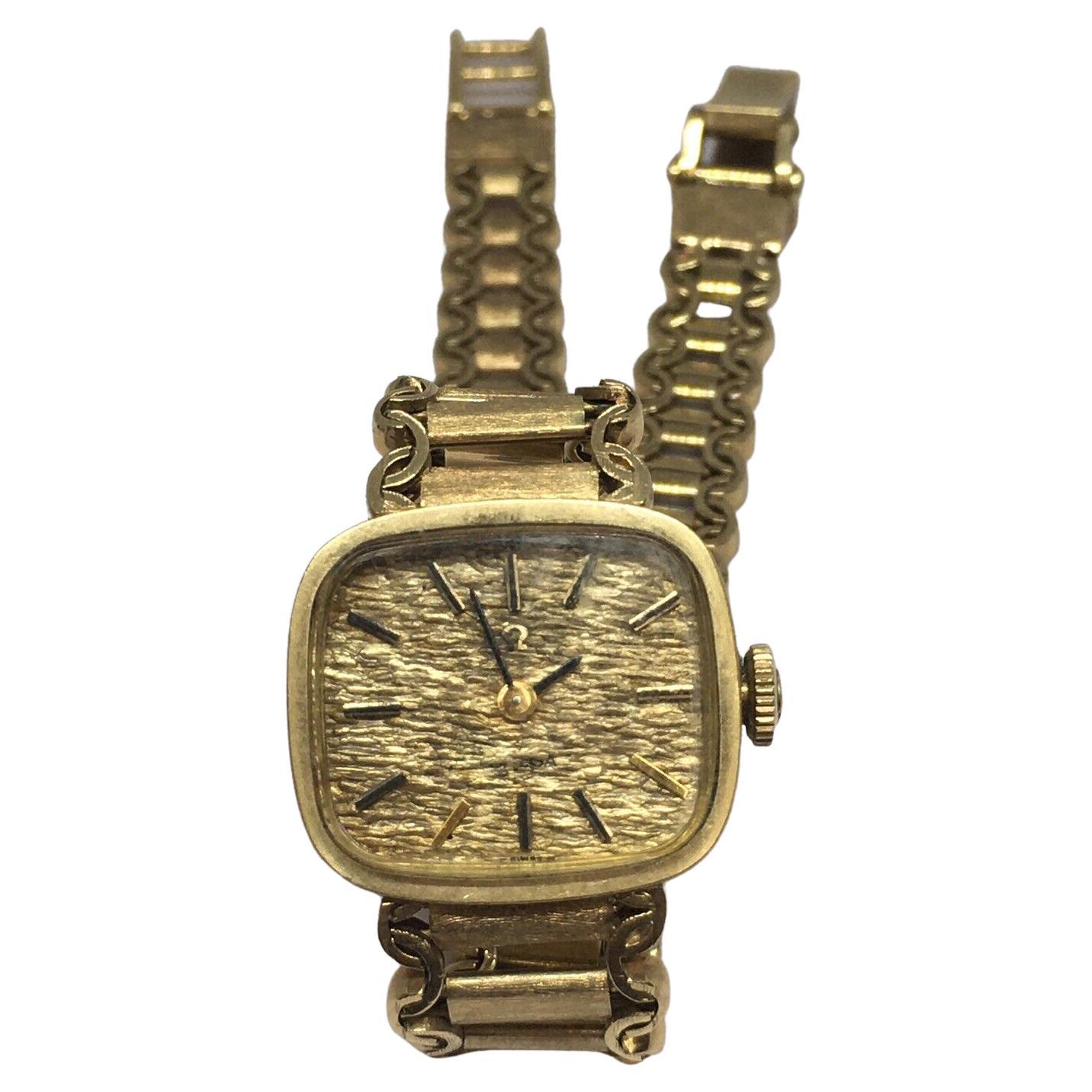 Omega Montre mécanique pour femme en or jaune 14 carats avec boîtier marqué, 8 pouces