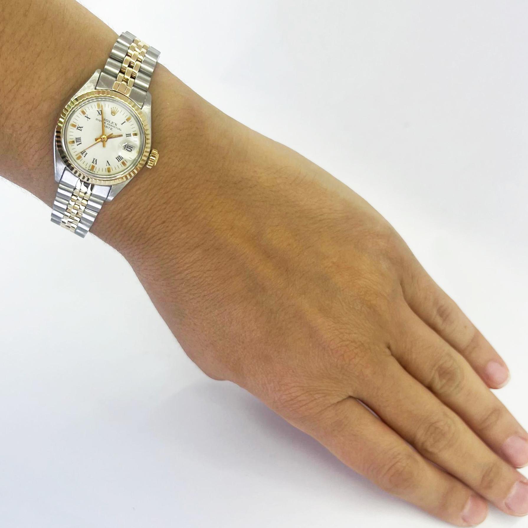 Pre-Owned 26mm Rolex Date automatic watch crafted in 18 karat yellow gold and steel with white roman stick dial and Jubilee bracelet. Model 6916 circa 1978. Serviced and polished by CW21 watchmaker with new Rolex parts in August 2024. Includes 1