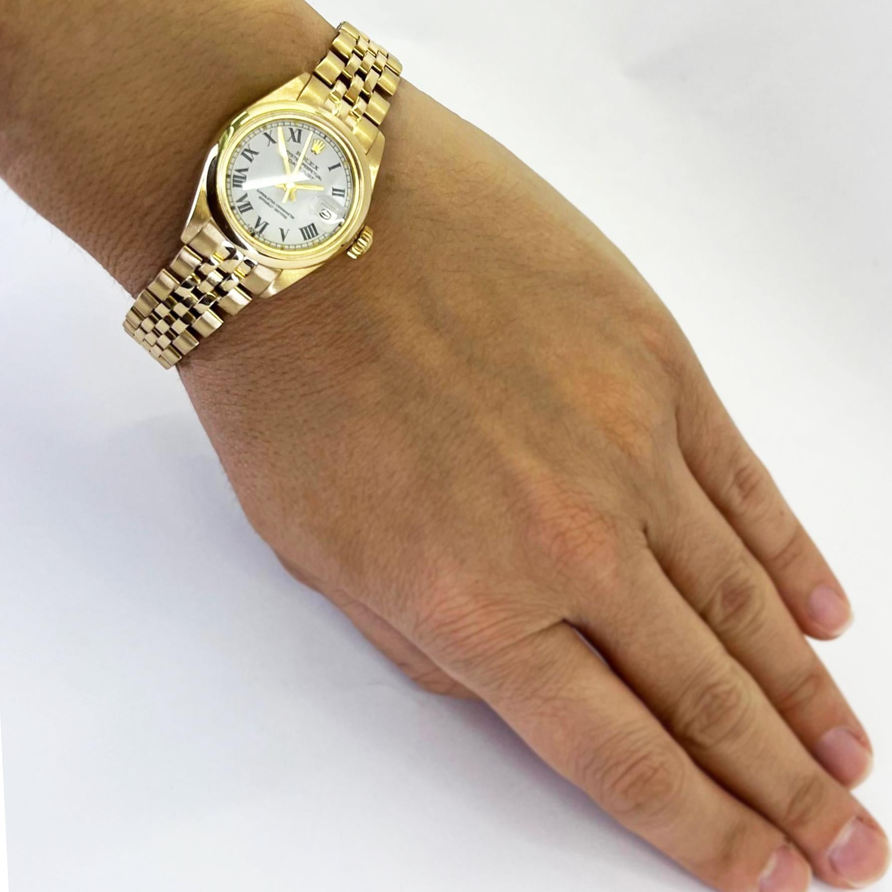 Pre-Owned 26mm Rolex Datejust automatic watch crafted in 18 karat yellow gold with white roman Buckley dial and Jubilee bracelet. Model 6916 circa 1978. Serviced and polished July 2024 by CW21 watchmaker with new Rolex parts. Includes 1 year