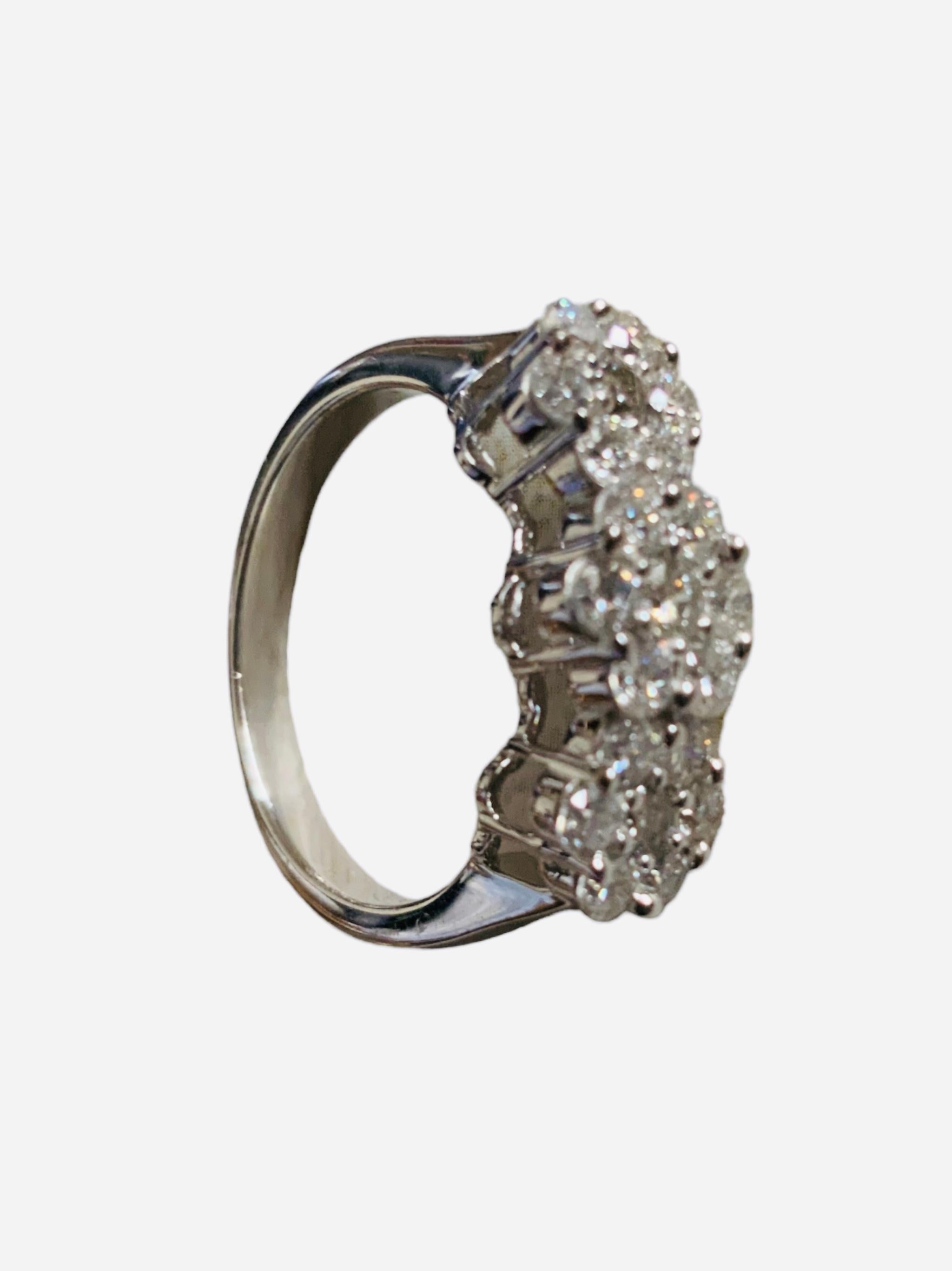 This is a one Lady’s triple cluster designs brilliant shaped diamonds ring. The triple cluster forms three flowers in a row that contains 21 brilliant shape diamonds ( Color- G-H; Clarity- VS to SI; Kimberly diamonds ) in prong setting weighing 1.05