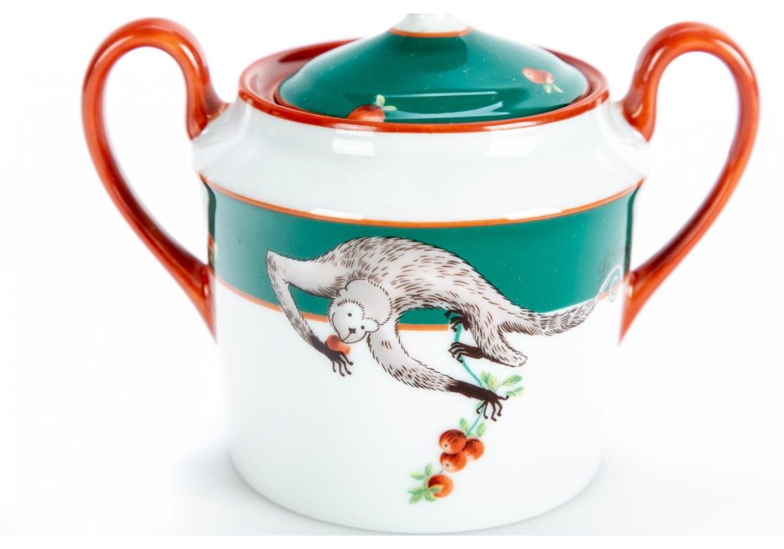 Lafarge Limoges for Le Cirque porcelain lidded sugar bowl displaying orange/rust trim and green band with imagery of monkeys picking fruit. Marked on verso by Larfarge Limoges for Le Cirque Restaurant.

Dimensions: 5 3/8