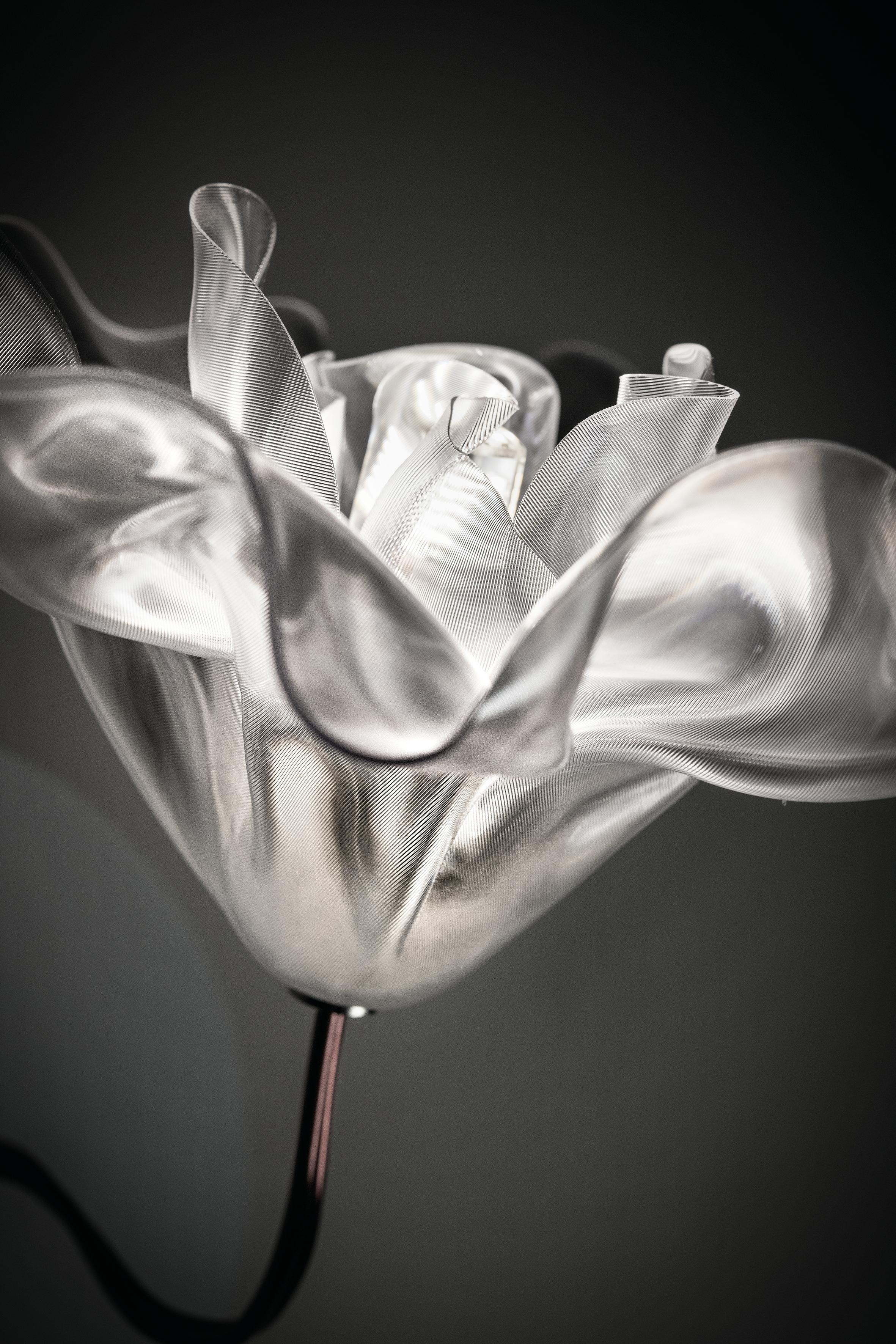 Marc Sadler manually sculpted Slamp's exclusive, unbreakable technopolymer Lentiflex at a controlled temperature to create an illuminated bloom. The LaFleur applique is available in Prisma or Velvet finishes, respectively with matte white or black