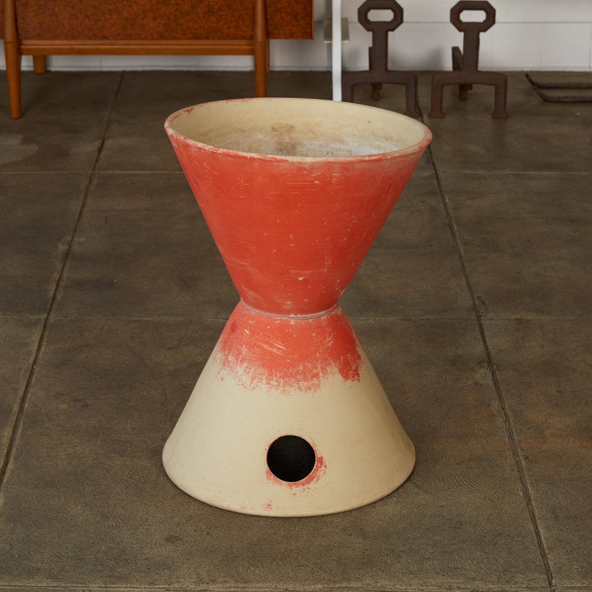 Lagardo Tackett's iconic double cone planter for Architectural Pottery. The is the larger version of the double cone form and has an unglazed natural bisque finish. The top portion was painted orange by the previous owner. Stamped [Architectural