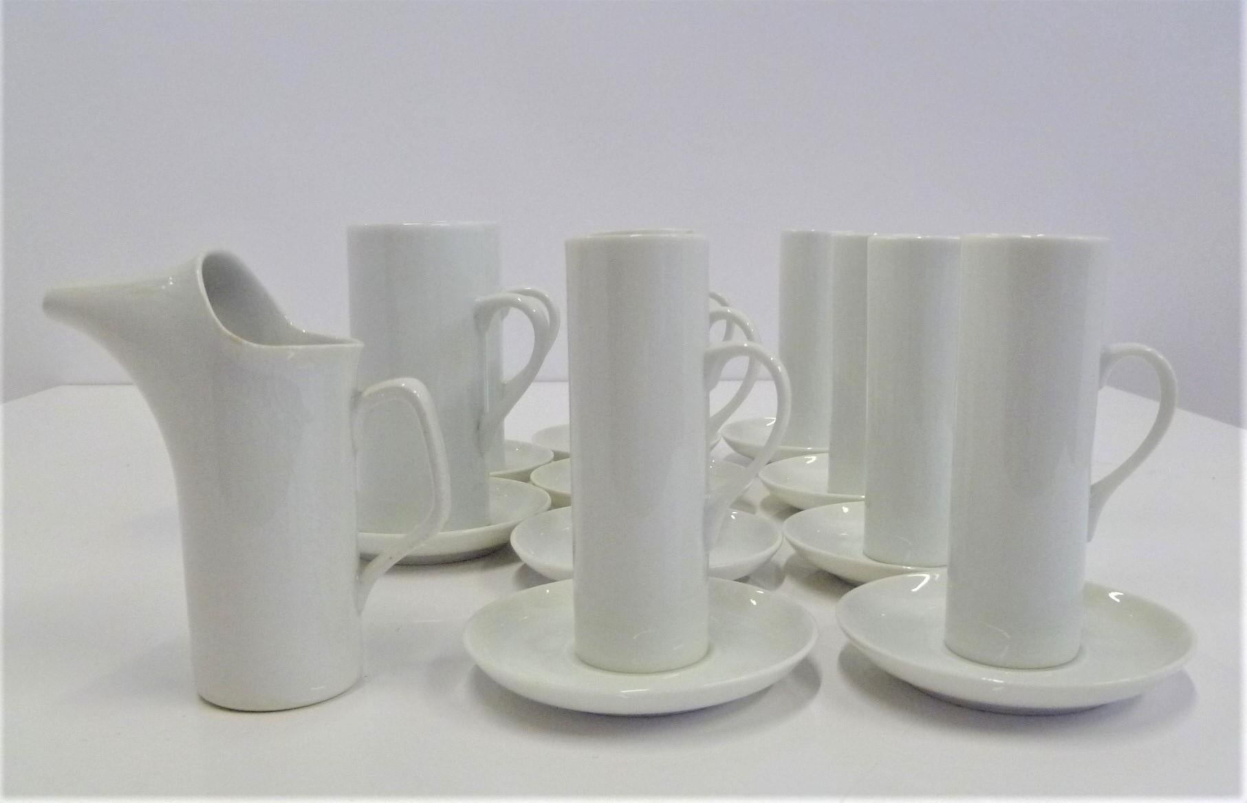 Mid-Century Modern set of white porcelain coffee set, a large grouping of 21 pieces. Consisting of 8 demitasse cups and saucers, 2 Irish coffee cups and saucers and one small creamer by Schmid International designed by LaGardo Tackett. Some pieces