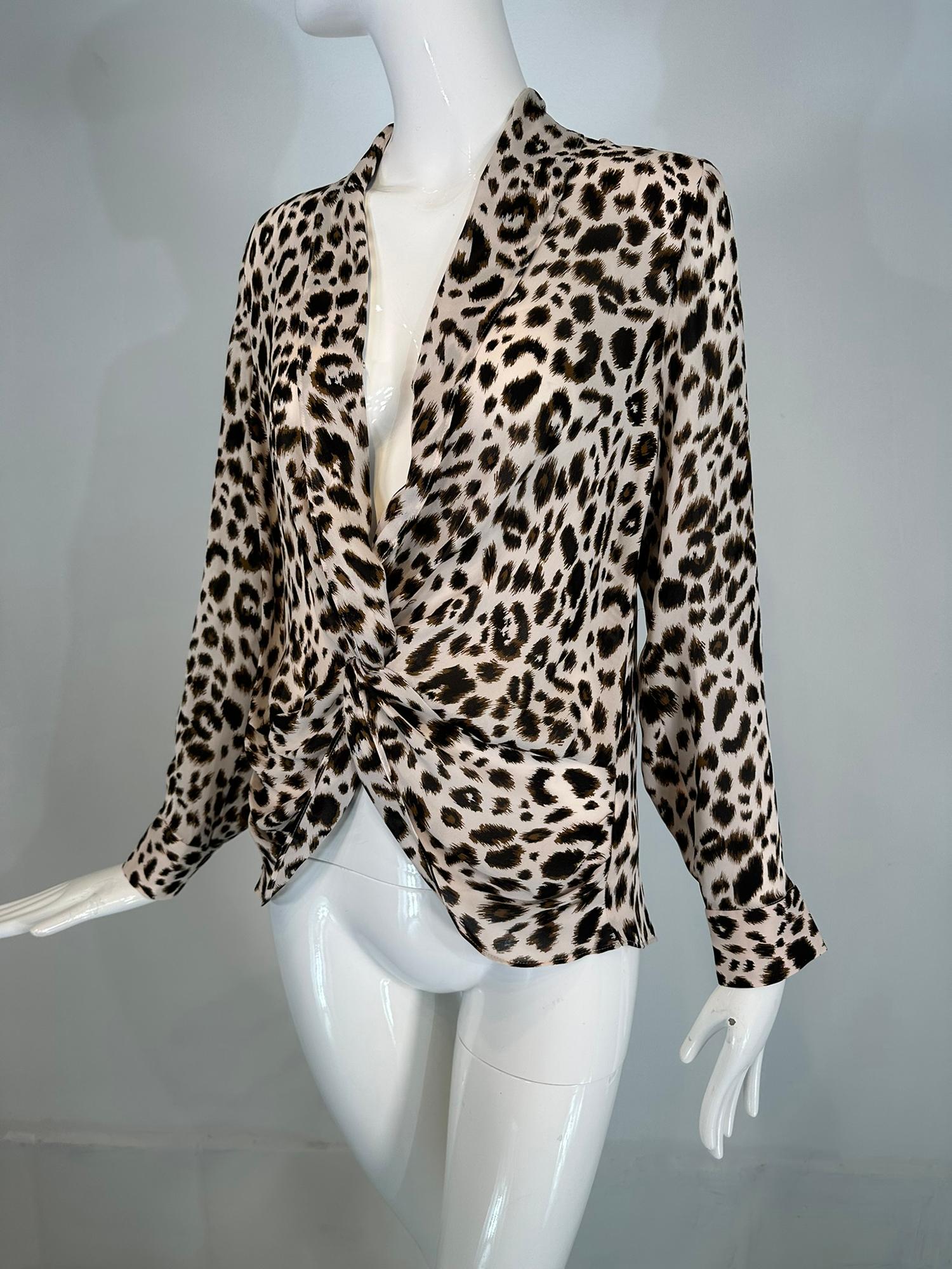 L’AGENCE leopard print silk plunge V neckline twisted wrap front effect blouse. Long sleeves with button cuffs, draped collar that extends with the twisted fabric front. The blouse pulls on. Looks barely, if ever, worn.
In excellent wearable