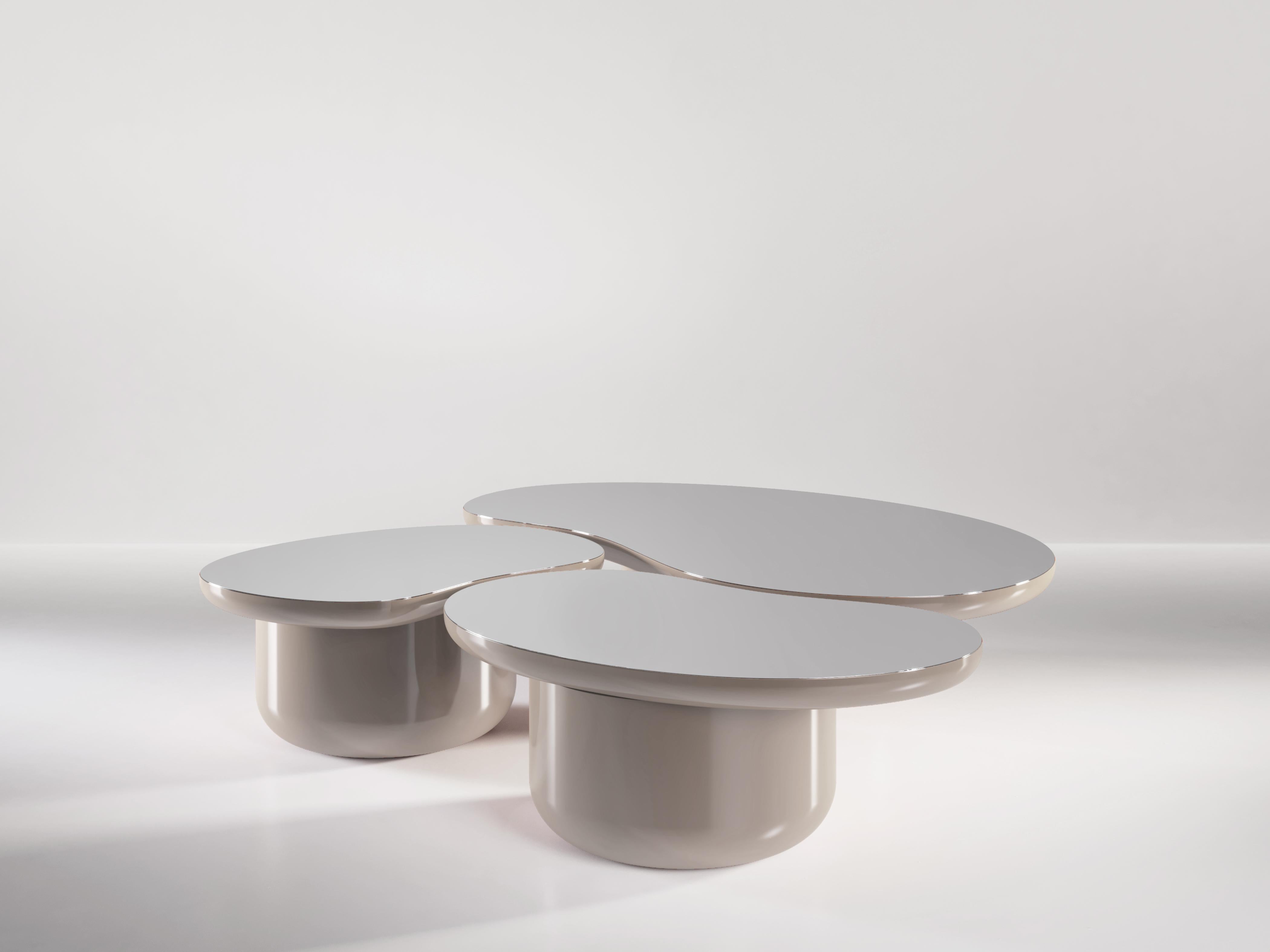 The Laghi coffee tables are a group of low coffee tables, each in the shape of a body of water and inspired by the peacefulness and beauty of the Lake District in United Kingdom. Each table is topped with a polished piece of aluminum to symbolize