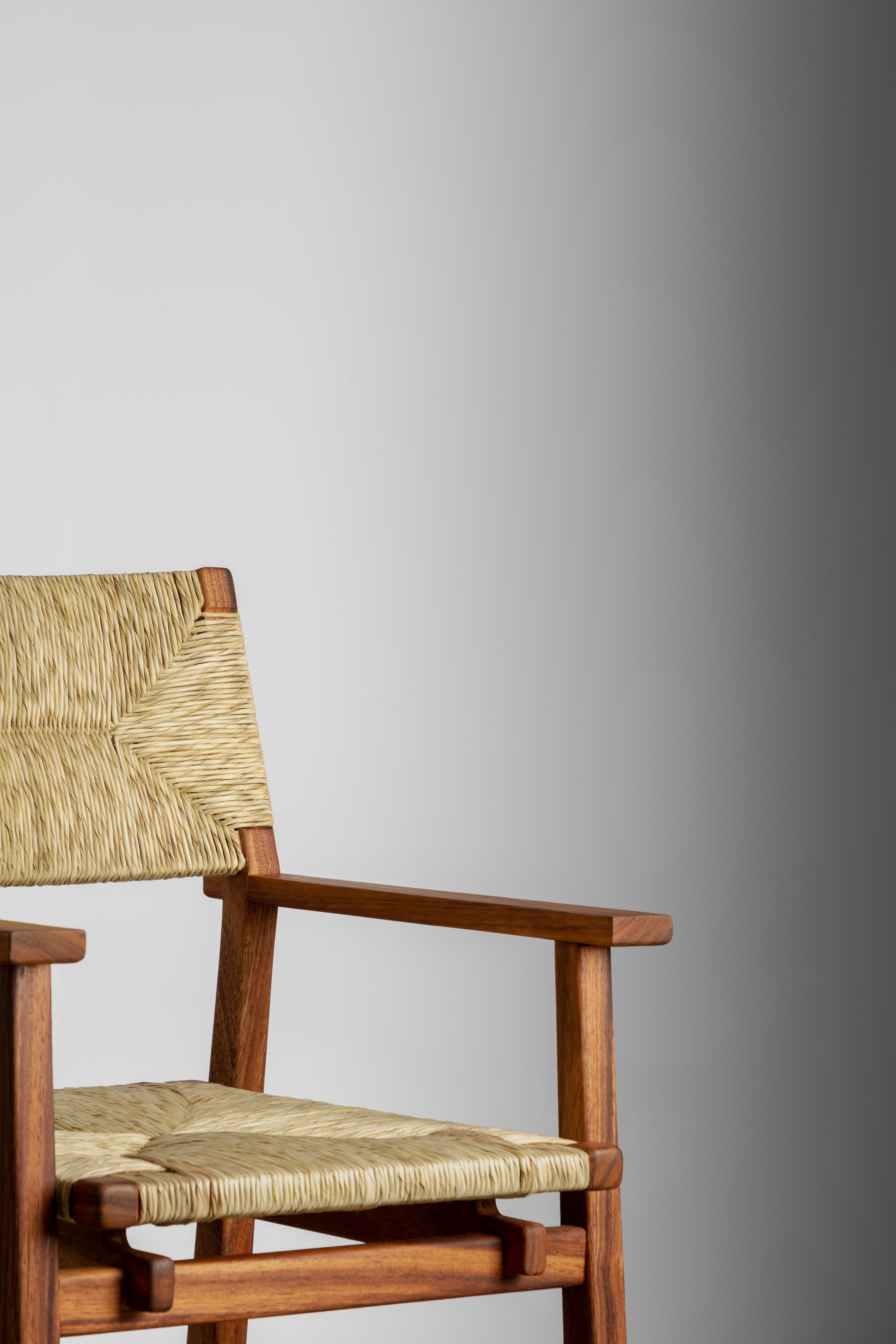 Palm woven armrest dining chair. Ideal for headboards or a large dining room, the hand-woven palm back and seat give a twist to the classic, understated design of this chair making it a relaxed yet elegant piece. We also have a version without