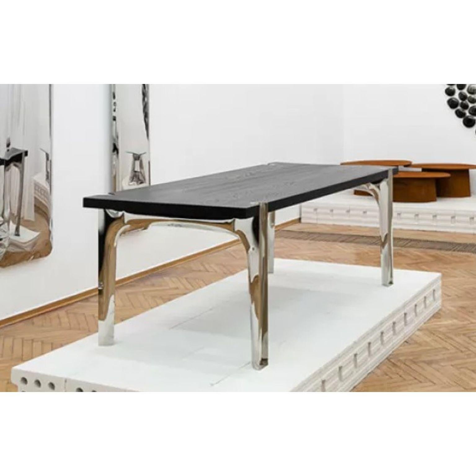 Lagom Oak Table by Zieta
Dimensions: D 95 x W 200 x H 75 cm.
Materials: Polished Stainless Steel Legs and Bog Oak top.

Tailor-made dialogue
Joining, separating and searching for balance, an intriguing juxtaposition of the durability and plasticity