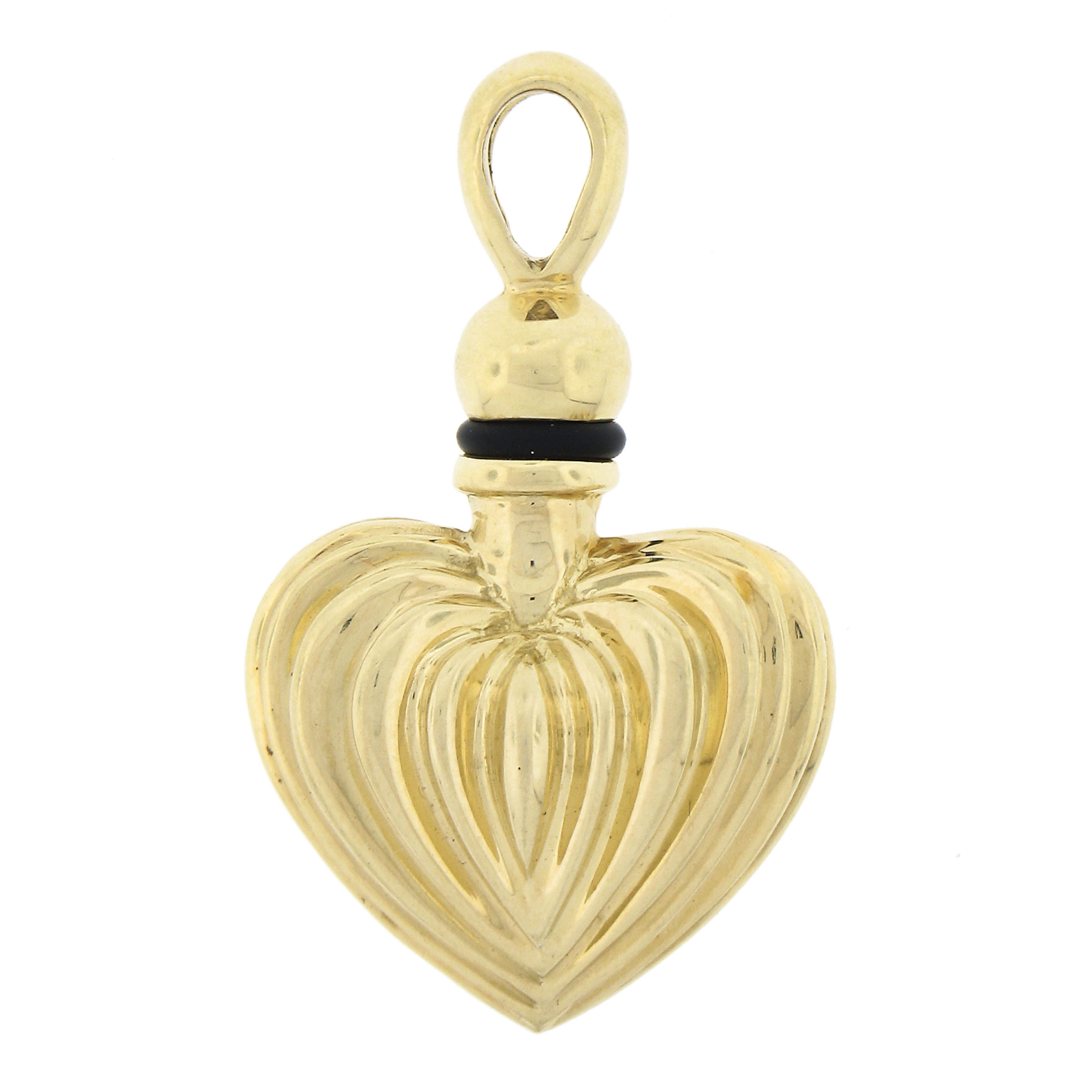 Here we have a beautiful perfume flask charm/pendant by LAGOS is crafted in solid 18k yellow gold and features a puffed fluted heart design that is very well preserved and has its original finish intact. The cap screws off and onto the heart and