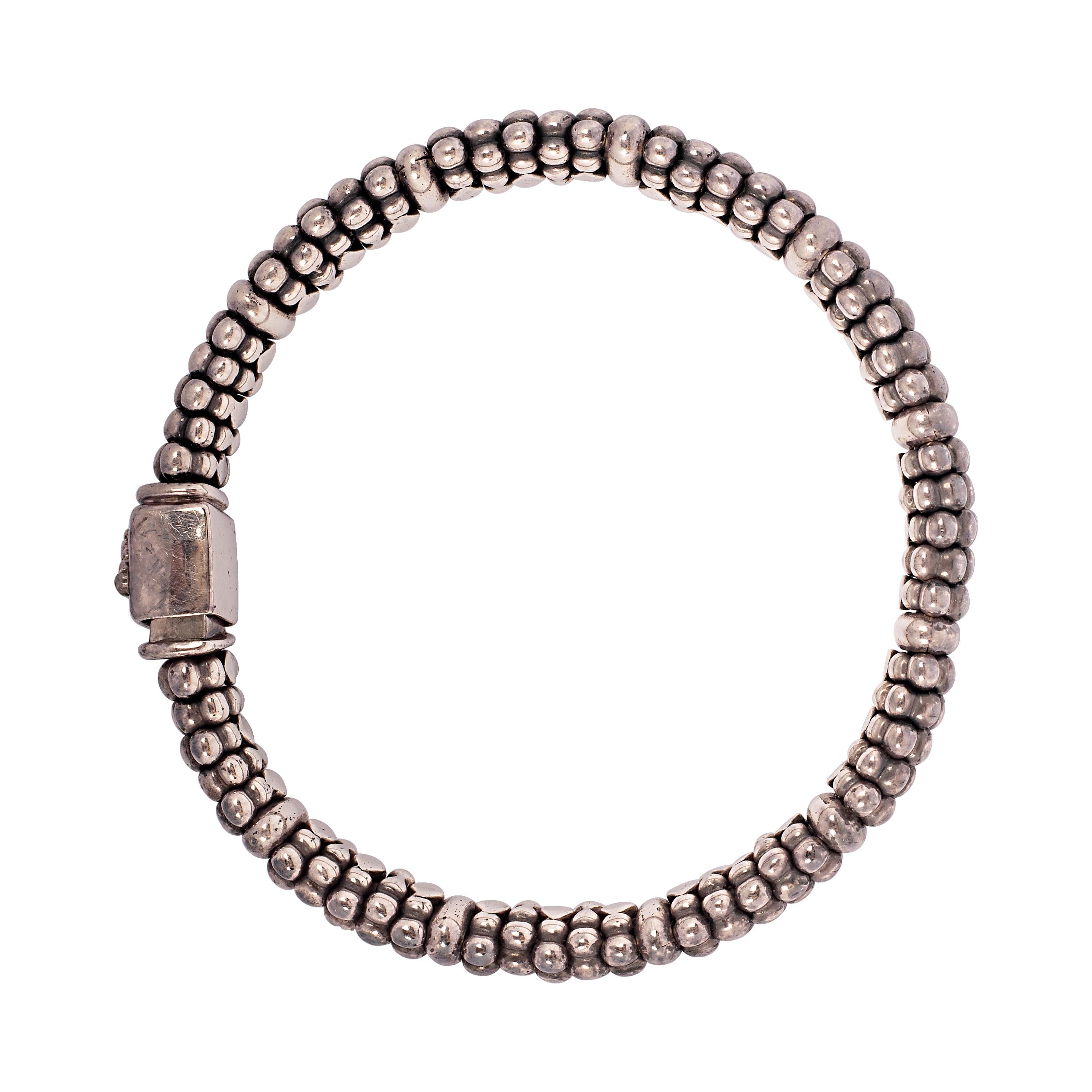This classic sterling silver Caviar bracelet by Lagos intersperses rows of beading with bands of smooth polished silver to create contrast and textural depth. Completed by a box clasp with the Lagos crest. The bracelet measures 6 mm in width and 7
