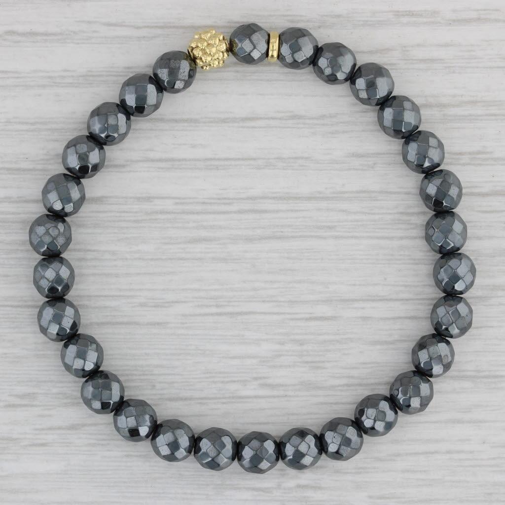 Gemstone Information:
- Hematite -
Size - 6.2 mm 
Cut - Round Faceted Bead
Color - Gray

Metal: 18k Yellow Gold
Weight: 18.5 Grams 
Stamps: 750 Lagos
Style: Stretchable Bead Strand
Closure: Pull Over
Inner Circumference: 7 1/4