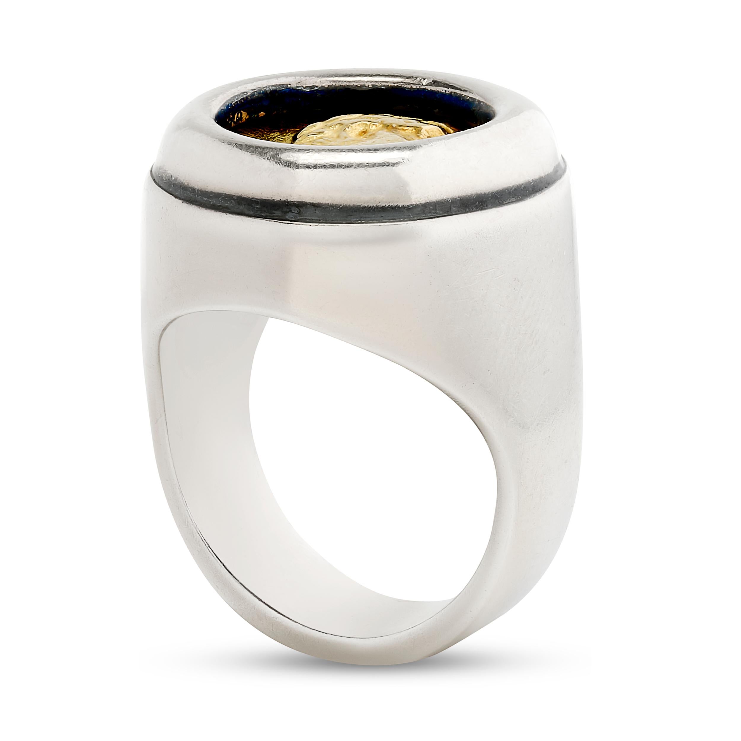 A stylish and textured Lagos Caviar ring featuring a silver coin bezel-set in 18K yellow gold.

Ring size 6.75 US.
Ring is stamped: 