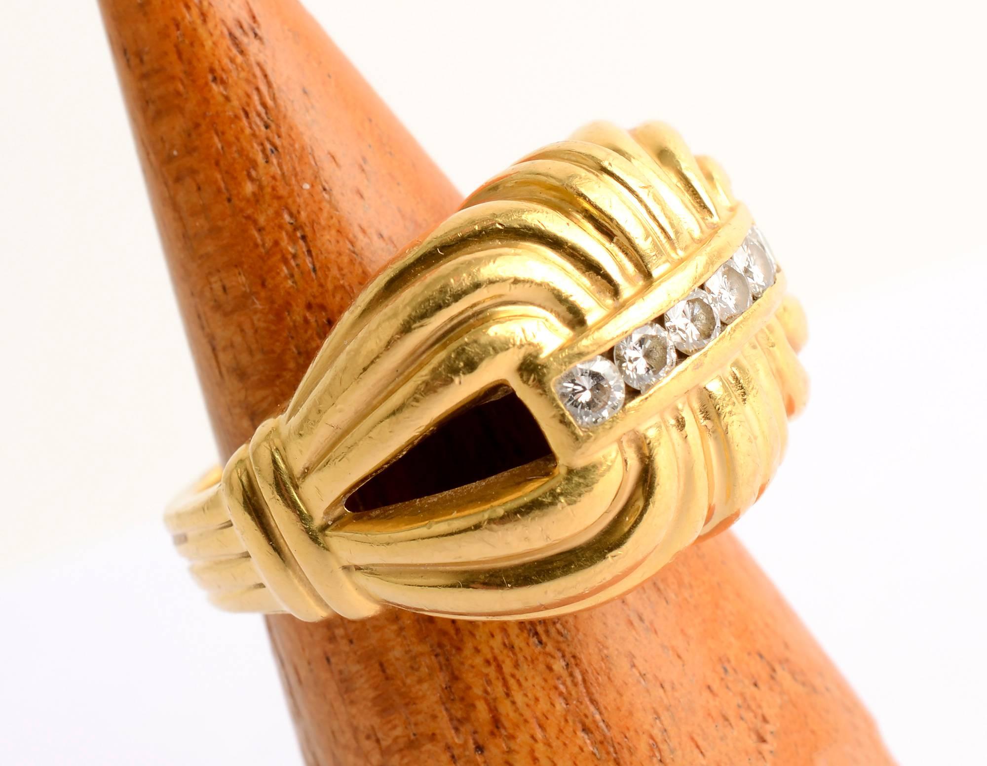 Scroll design ring by Lagos made of 22 karat gold with six diamonds. The banded design continues throughout the shank.
The ring is size 7 1/2. This substantial ring  would look equally good worn by a man or woman.