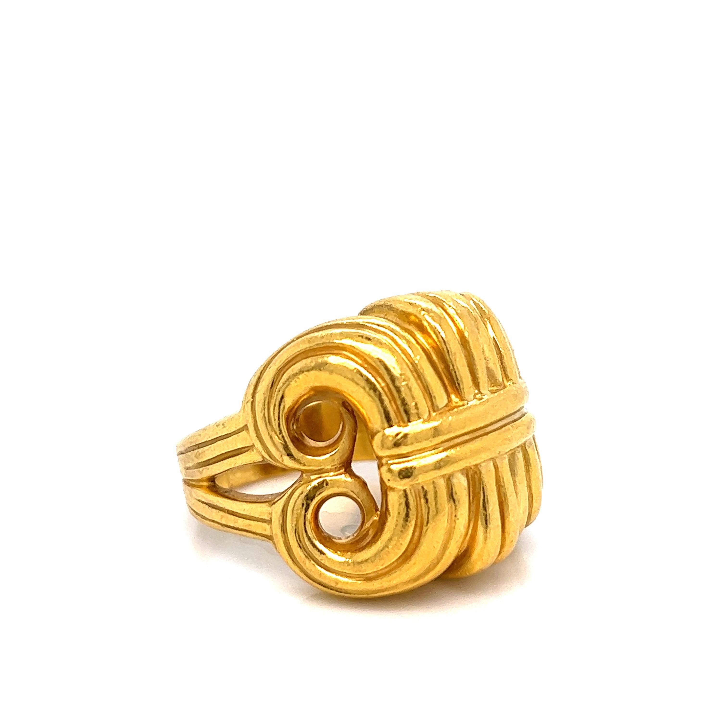Lagos 22 karat yellow gold ring that features a ram's horn sheath design. The top's measurements are 22.6 mm x 24.2 mm. Size 10.5. Serial no. 26927. Marked: Lagos / 22k / 26927. Total weight: 25.1 grams. 