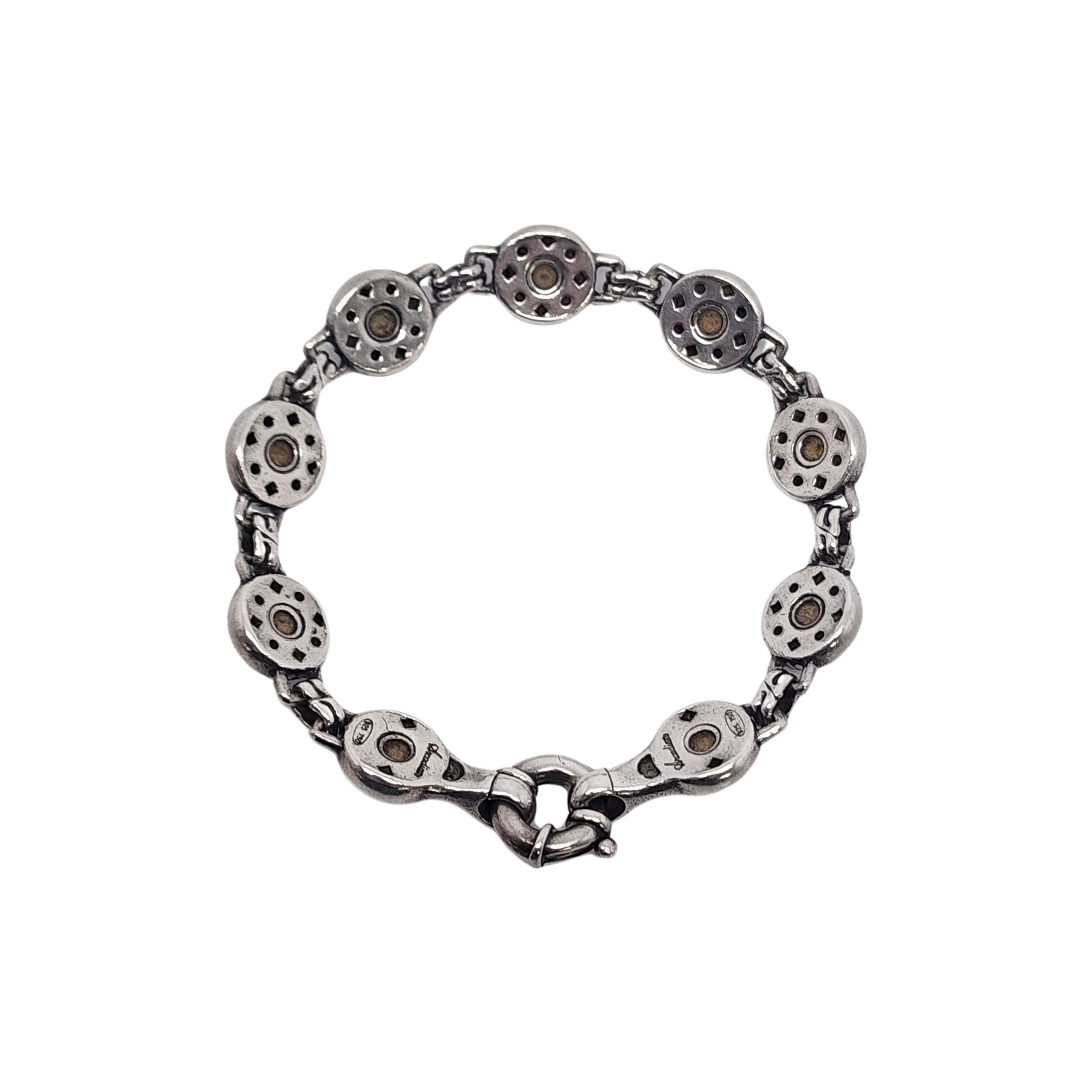 Lagos sterling silver 18K plated accent Arcadian Link bracelet.

Sterling silver round links each feature flowers with 18K gold plated petals. Spring ring clasp.

Measures approx  6 3/4