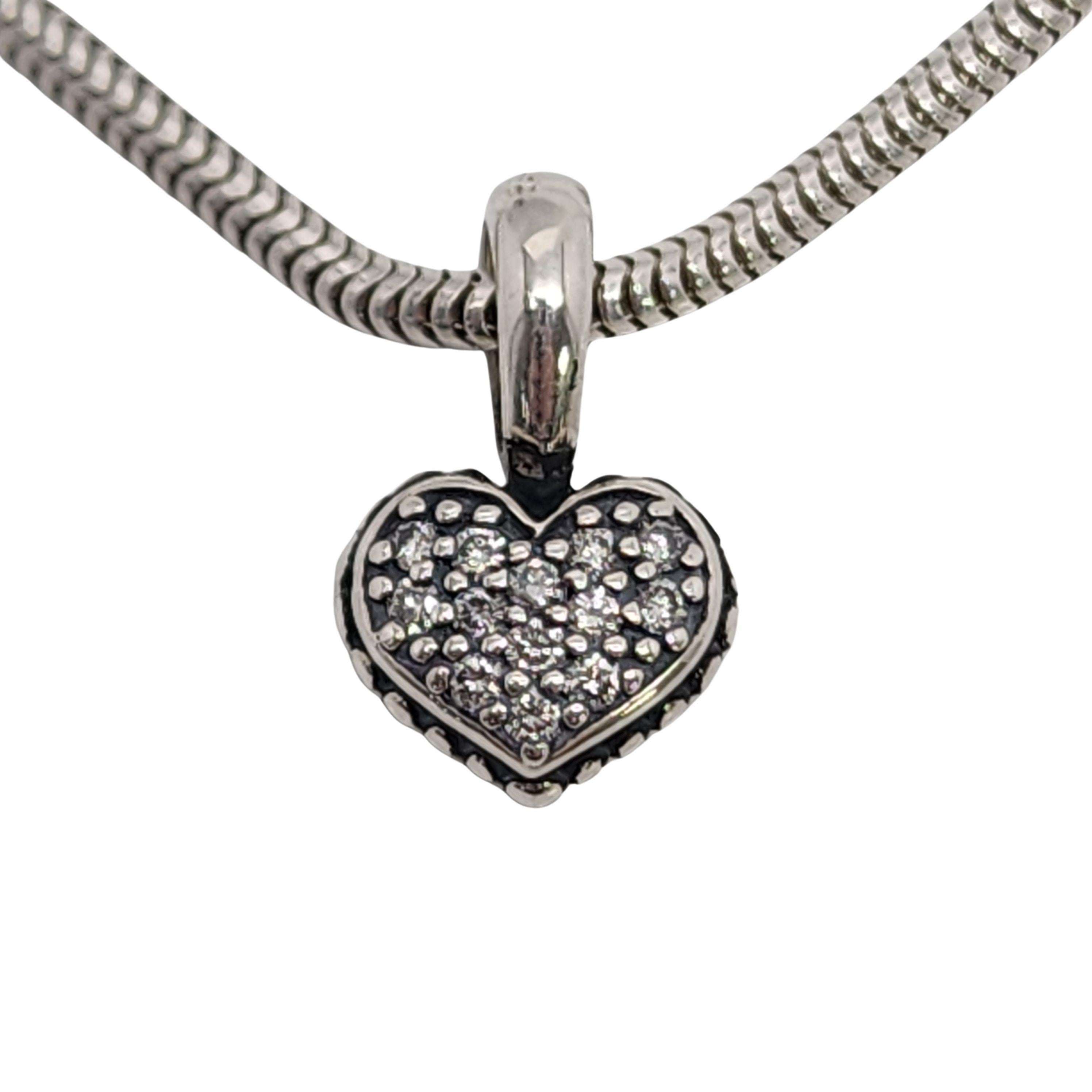 Lagos sterling silver 18K yellow gold plated reversible pave diamond heart pendant.

Beautiful reversible heart pendant on a snake chain. One side of the heart features 13 small round diamonds that total .10tct. SI clarity, H color. The other side