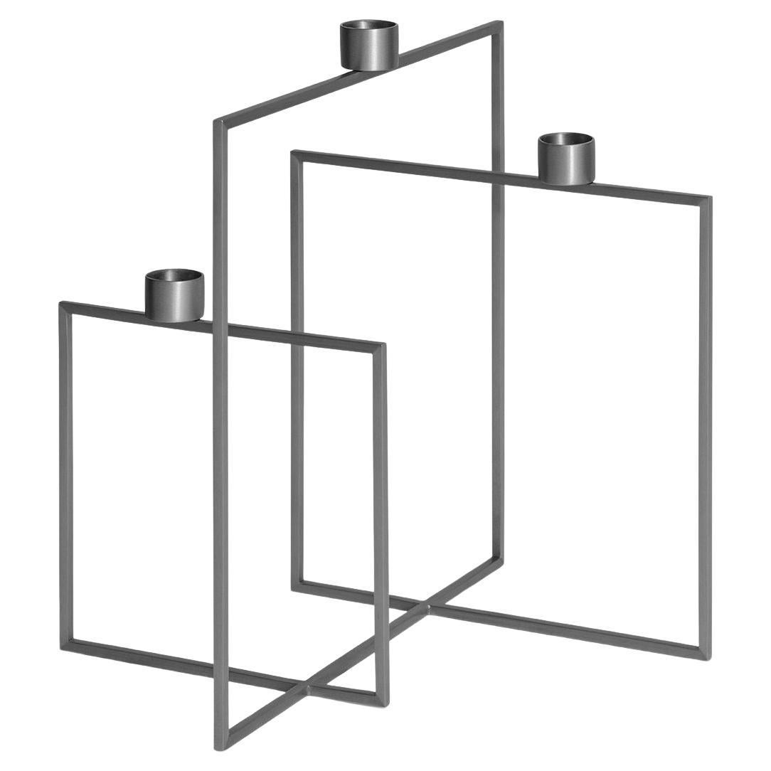 The candlestick is an elegant product with a capacity of three candles, offered in stainless metal and brass variations. Its geometric design, in which three squares are intertwined, offers a different perspective from every angle, adding a modern