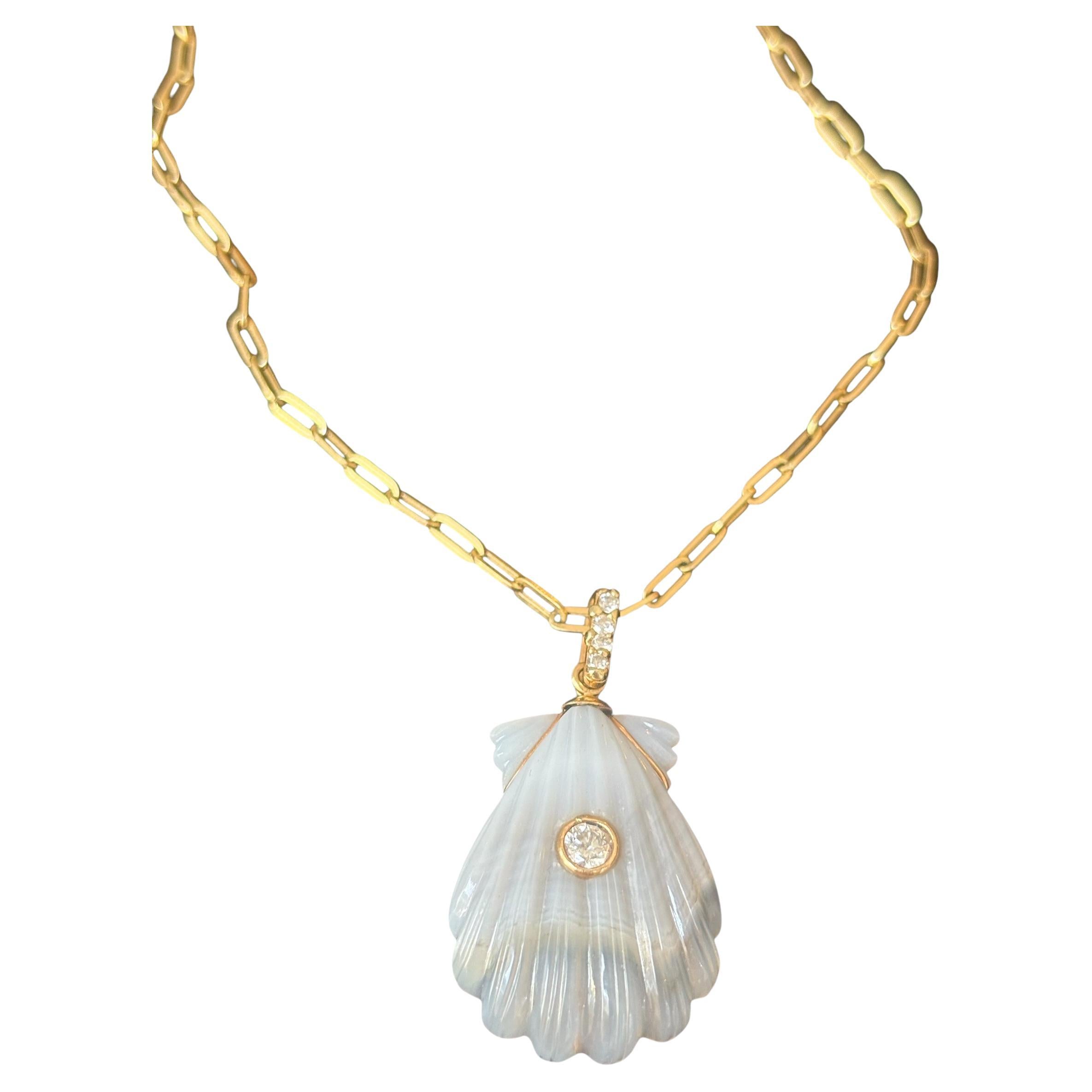 Laguna Agate Shell Necklace

Laguna Agate, Diamonds & 14k Yellow Gold Paperclip Chain

A beautifully carved Laguna Agate shell (24x20mm) with a center 3mm diamond bezeled in 14k gold. The 14k gold bail has four 1.5mm diamonds. 

The chain is a 2.1mm