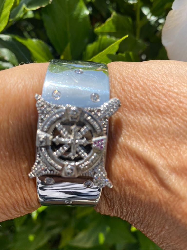 A customized jewelry cuff is one of a kind unisex statement item.

This exception bracelet is custom-made with the signature emblem of the  Lifeguard symbol. The diamonds are set at the top surrounding the logo, with tiny rubies accenting at noon.