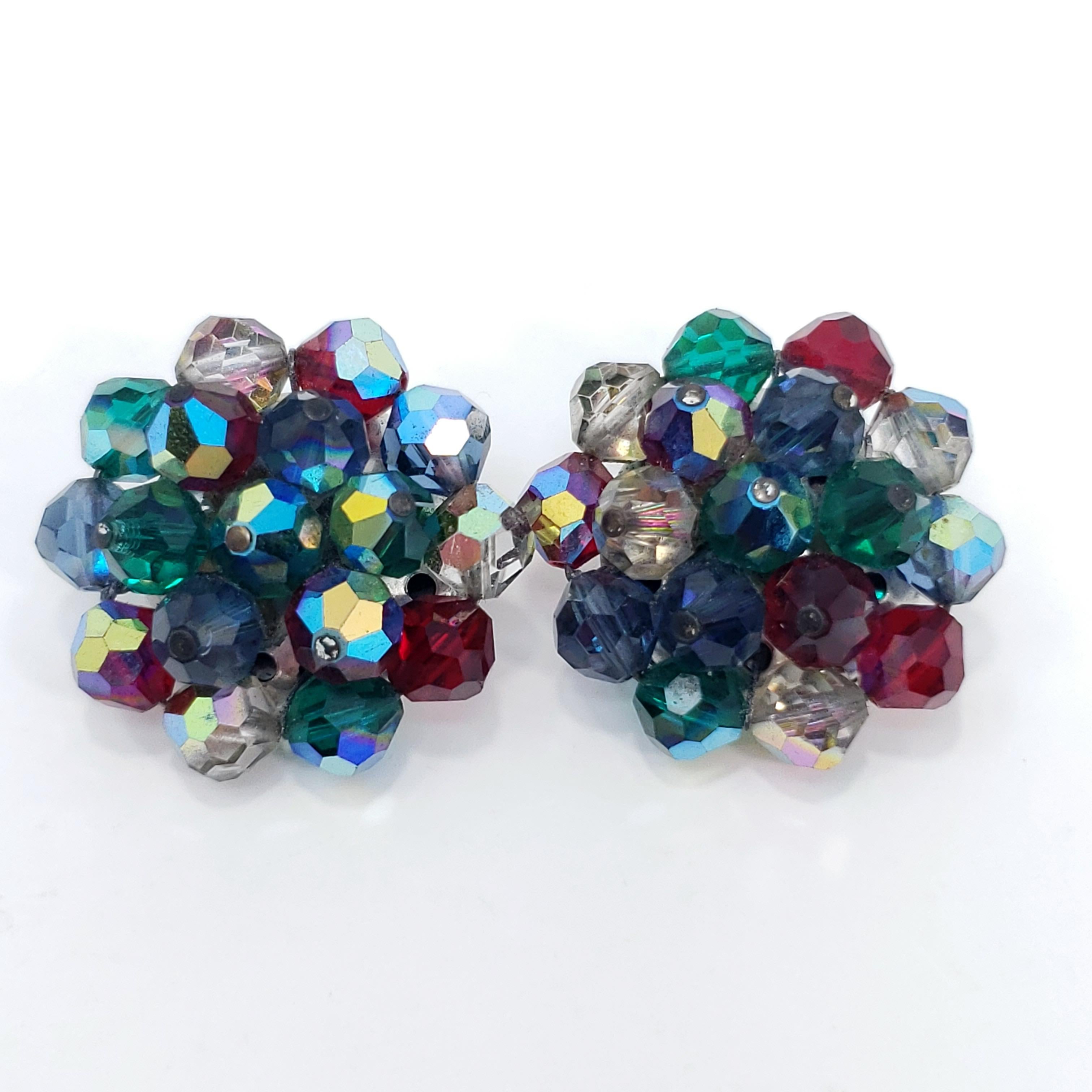 A touch of retro flair! These Laguna silver clip on earrings are decorated with glamorous aurora borealis crystals in emerald, ruby, and clear colors.

Circa 1950s. Made by New York-based fashion jewelry designer Laguna, founded in the 1940s.