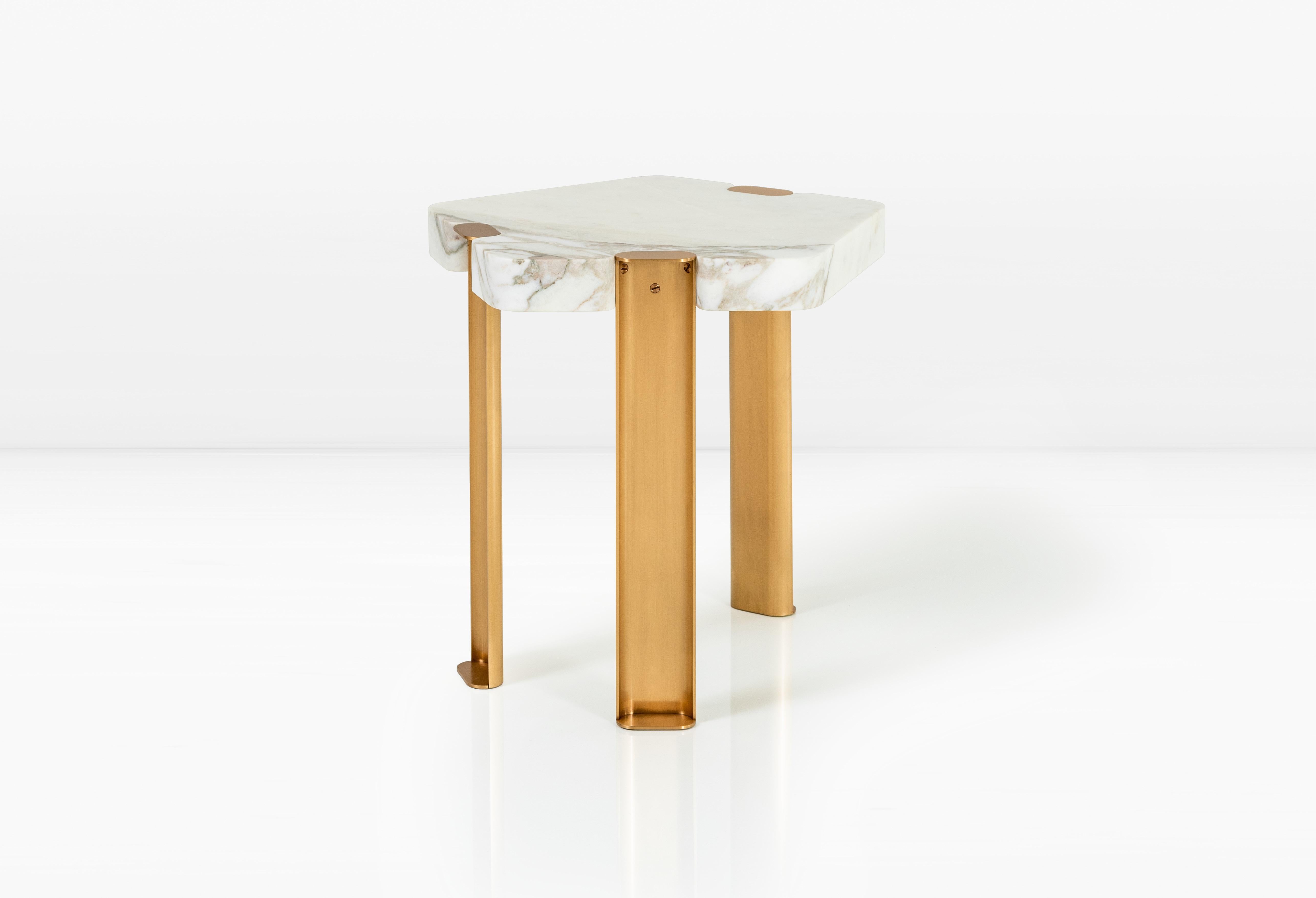 The Laguna side table is the exploration of a rarely used shape in design: the pentagon. The five-sided form of Calacatta Vagli marble is softened by the addition of lozenge shaped leg assemblies in solid bronze. The Laguna provides an unexpected