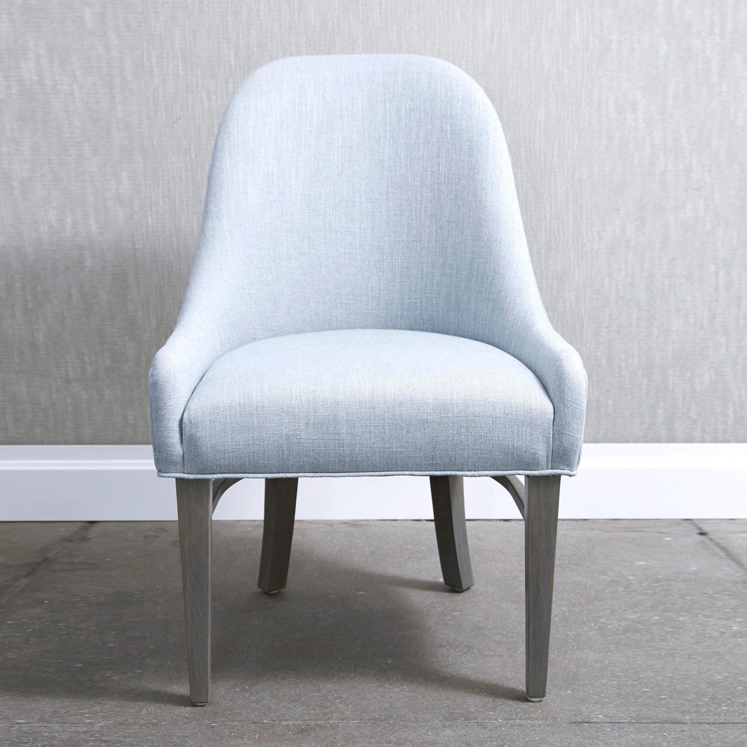 Barrel back dining chair with low arms. The Laight chair frame is constructed using solid maple wood. Four finishes available for chair legs. Available in four cotton fabric options or can be upholstered using customer's own material.