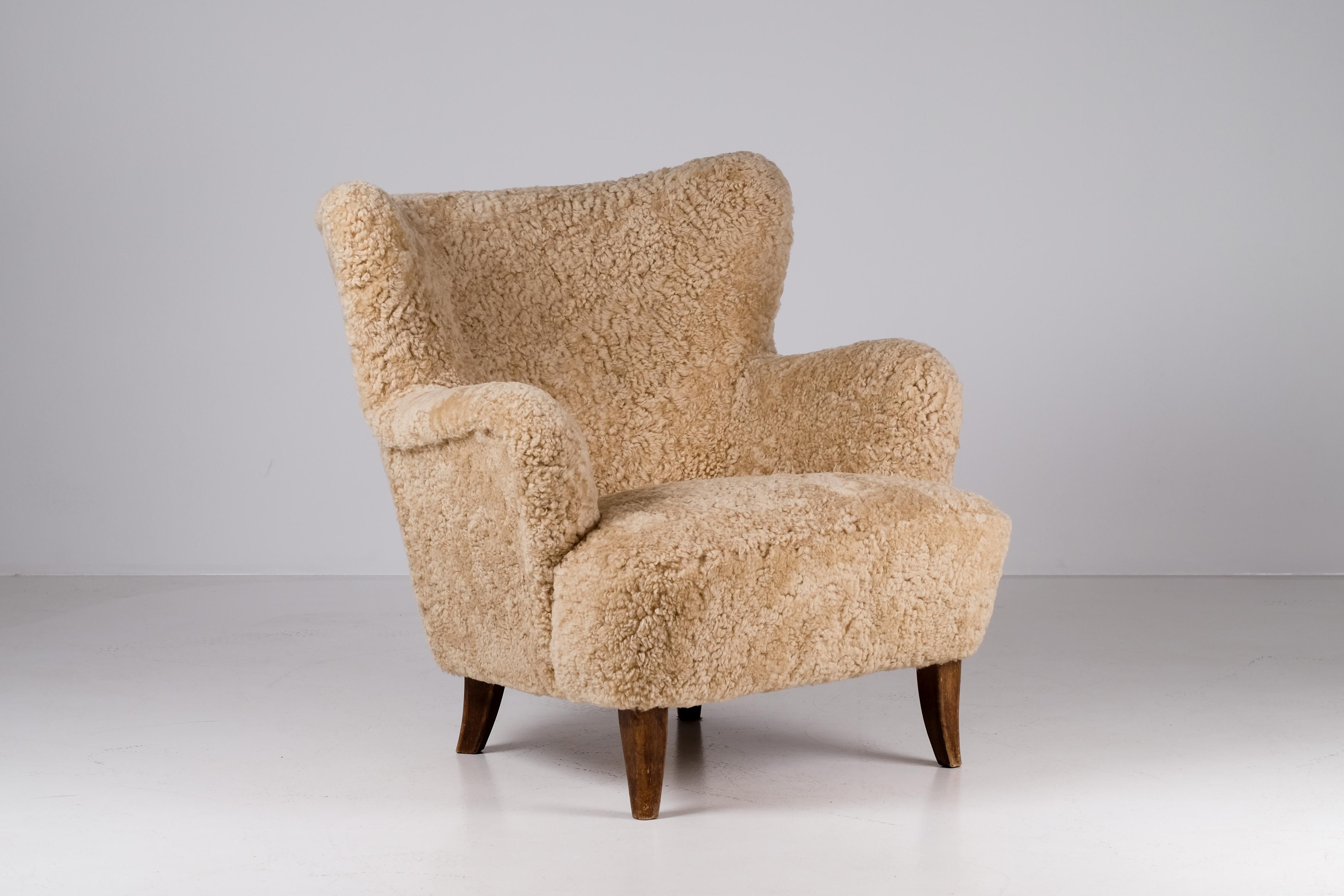 Excellent condition. Newly reupholstered in honey colored sheepskin. 
Set of 2 available. Listed price is for a single.