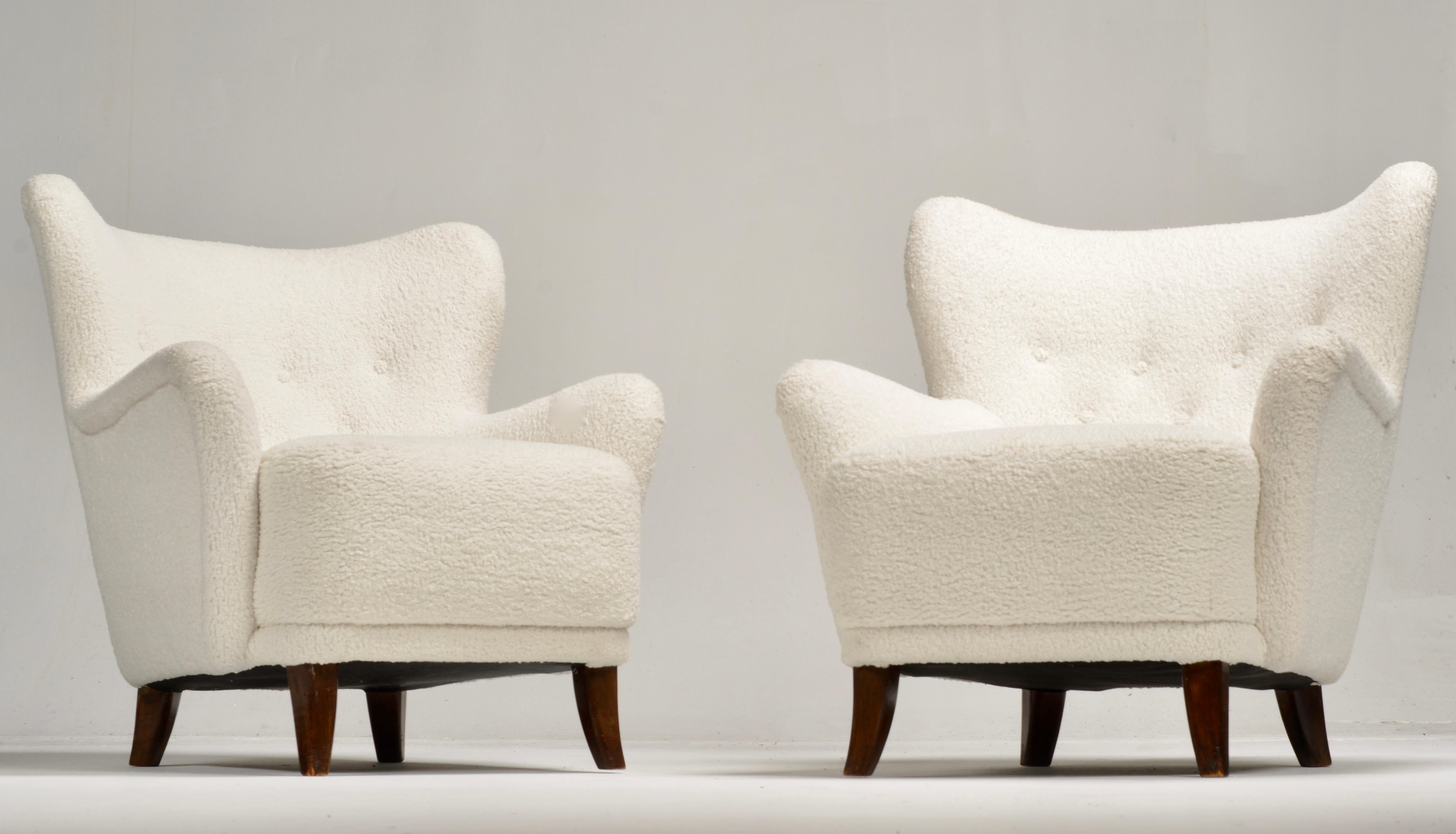 A pair of armchairs designed by Ilmari Lappalainen and manufactured by Asko Oy in Finland in the 1950s - upholstered with Lauritzon's 'Poodle' fabric. 
