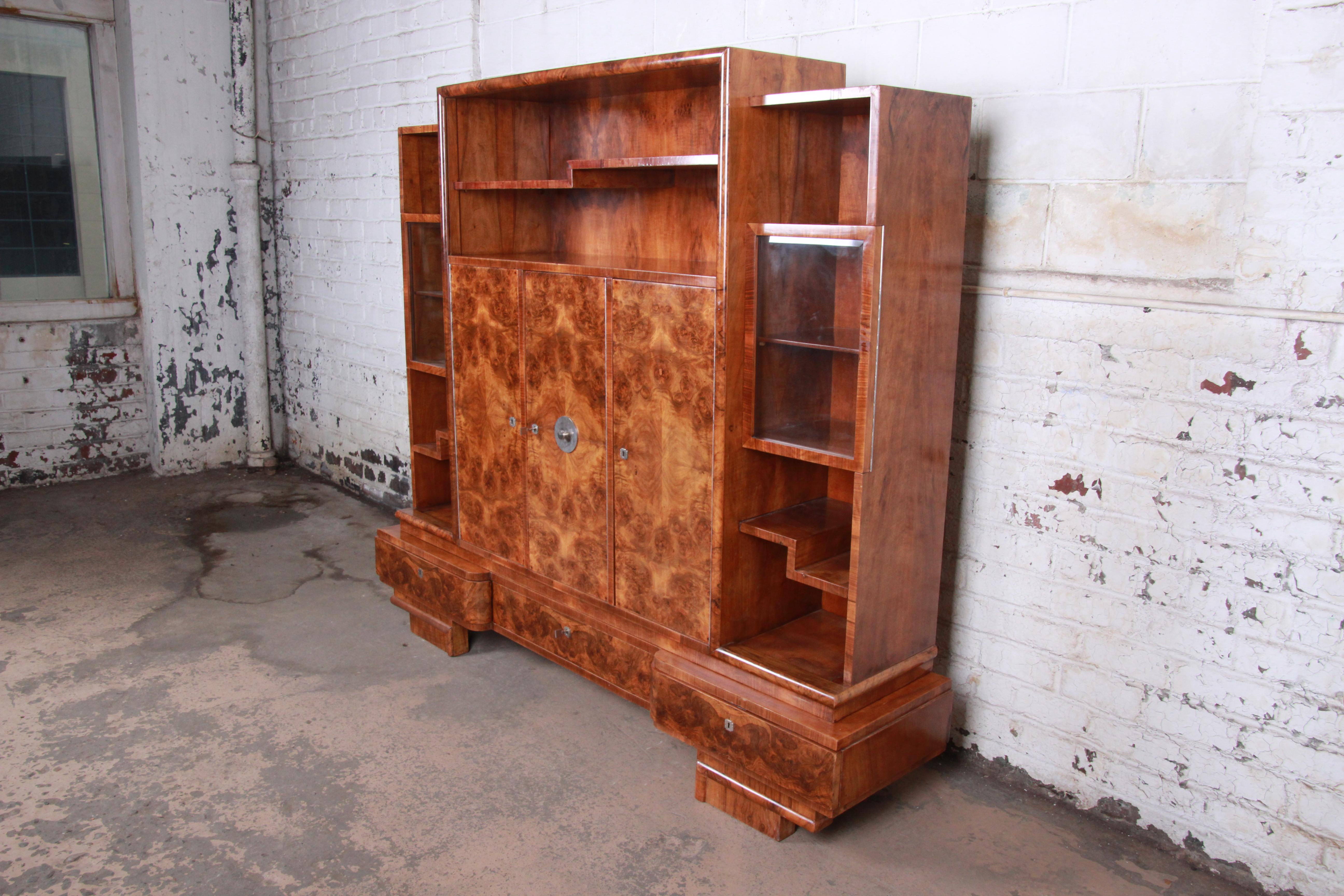An extremely rare and exceptional Art Deco bookcase wall unit or bar cabinet

Designed by famed architect Lajos Kozma

Hungary, 1930s

Bookmatched burled rosewood and chrome hardware and glass

Measures: 79.75