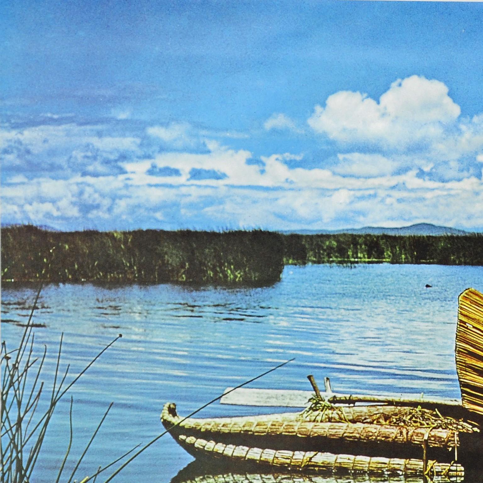A fantastic pull-down wall chart depicting the landscape of Lake Titicaca with reed islands and dugout canoe. Used as teaching material in German schools. Colorful print on paper reinforced with canvas. Published by Georg Westermann, Braunschweig.