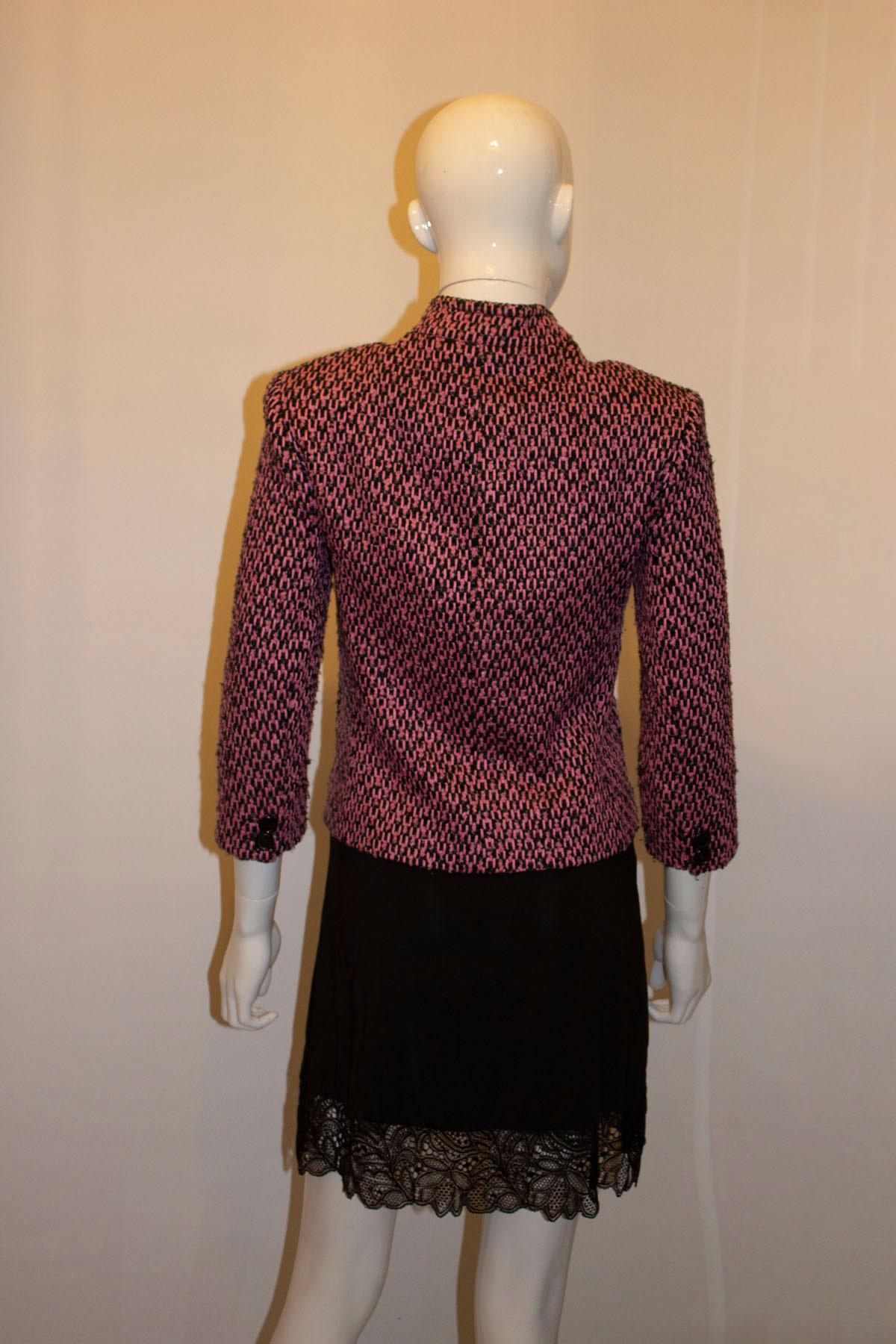 Perfect for Spring, a pretty pink and black boucle jacket from Lalage Beaumont. The jacket has a stand up collar, button front opening, four pockets on the front, and two buttons on each cuff.
Made in the UK Size 10 . Measurements; Bust 35/6'',