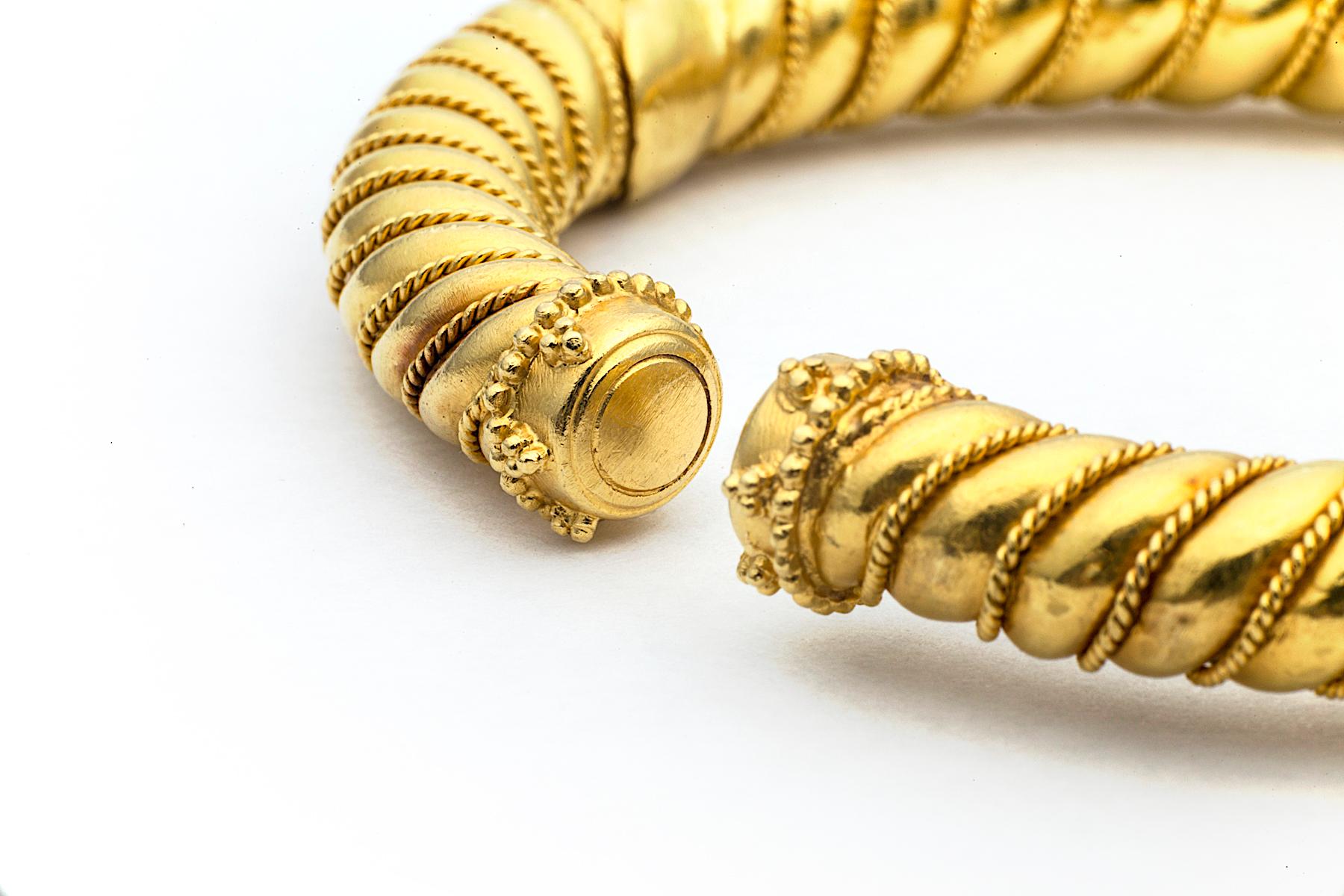 You'll twist and shout when wearing this vintage Lalalounis 22 karat yellow gold hinged cuff bracelet.  With a fine patterned rope design rhythmically twisting around its warm honey colored surface, this elegant bracelet stands alone or when stacked